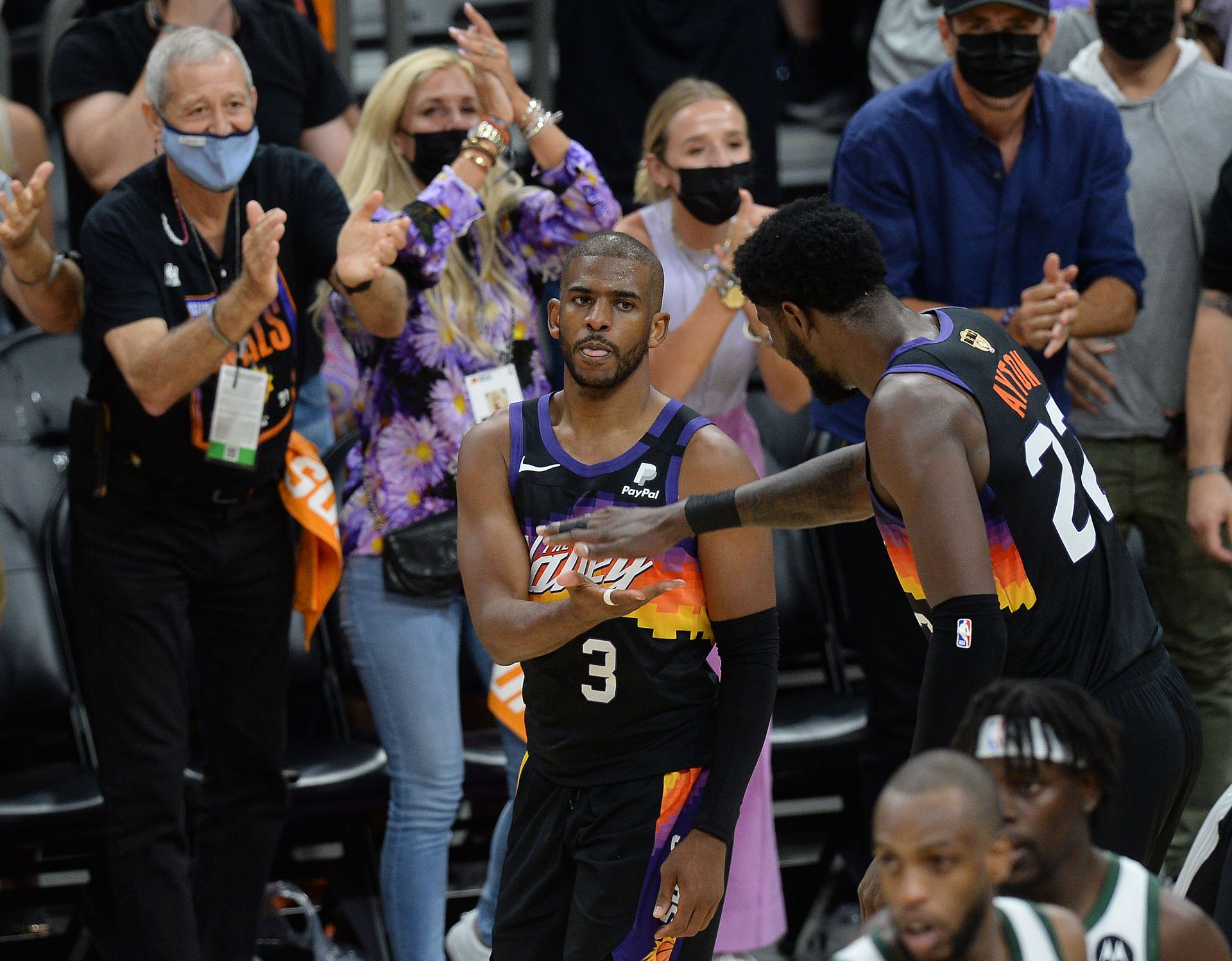 Phoenix Suns center Deandre Ayton (22) greets guard Chris Paul (3) after his basket scored against the Milwaukee Bucks during the second half in game one of the 2021 NBA Finals at Phoenix Suns Arena on Tuesday.