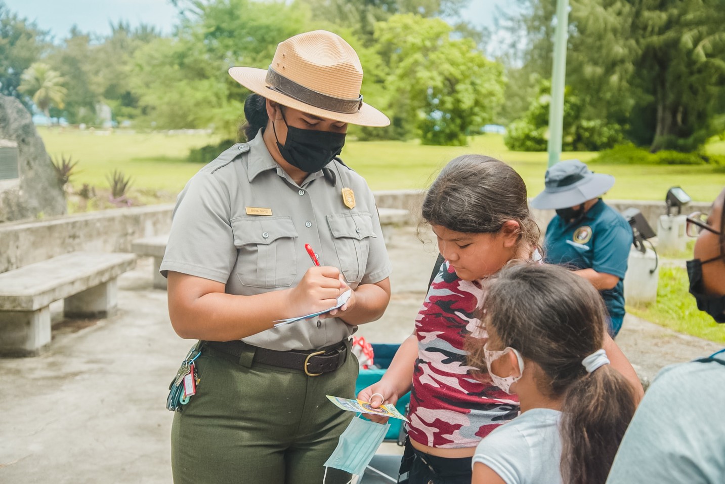 Park Ranger Brenalyn Santos autographs the campers’ passports.
