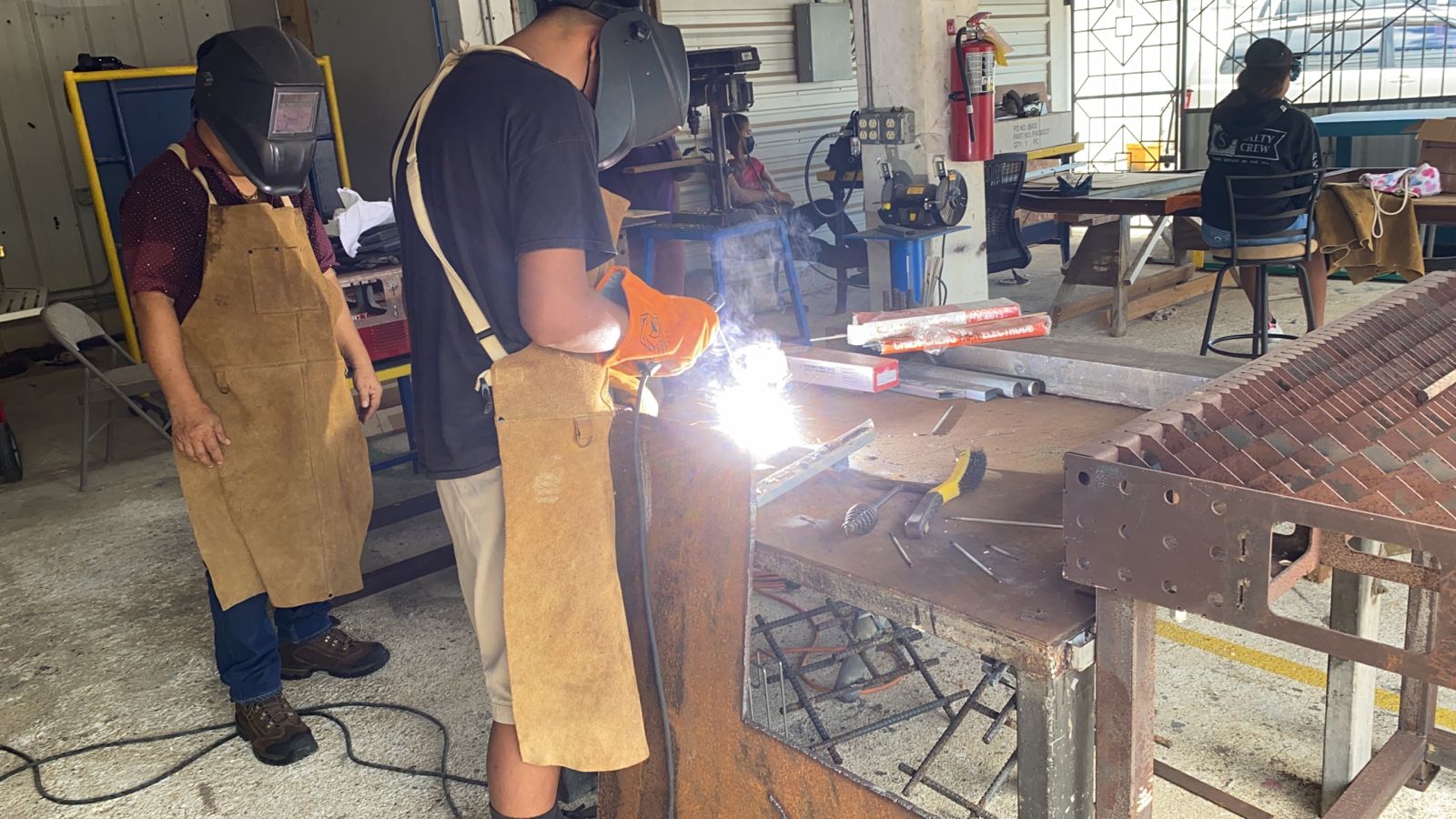A student performs a welding task.