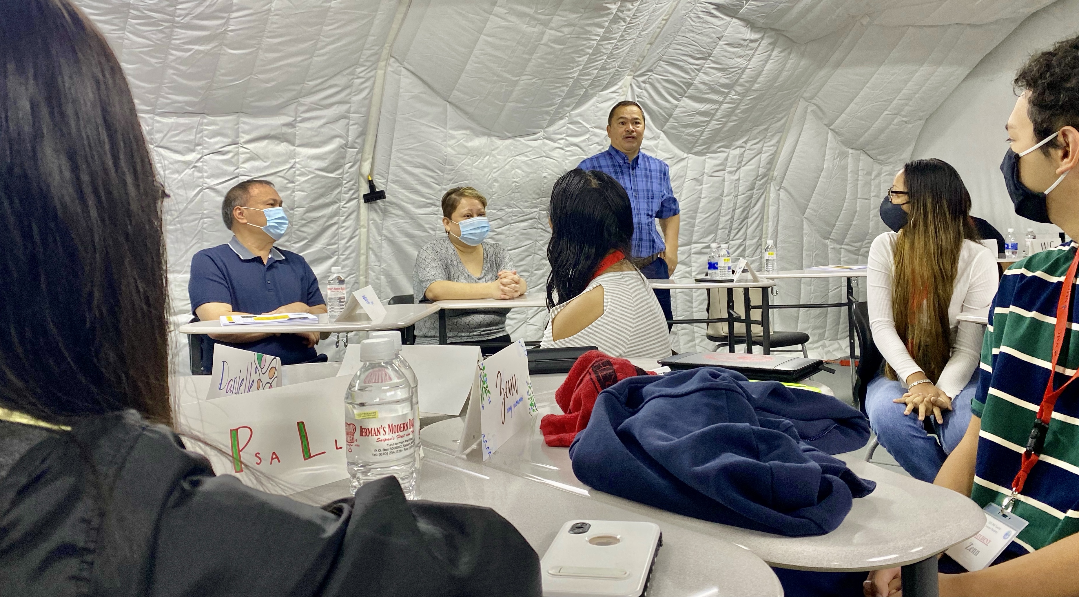 Students listen to Commissioner of Education Dr. Alfred Ada.