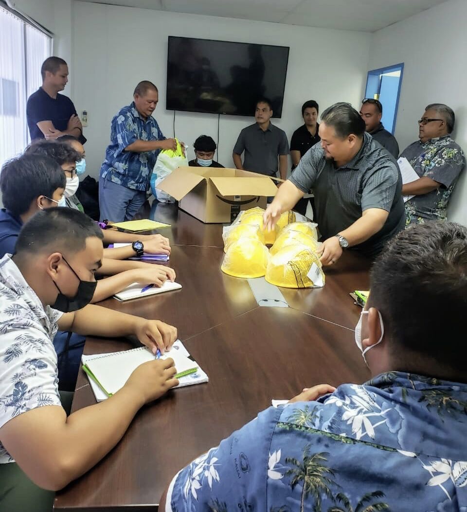 Public Works Secretary Ada and his directors distribute personal protective equipment to the Construction Boot Camp participants.