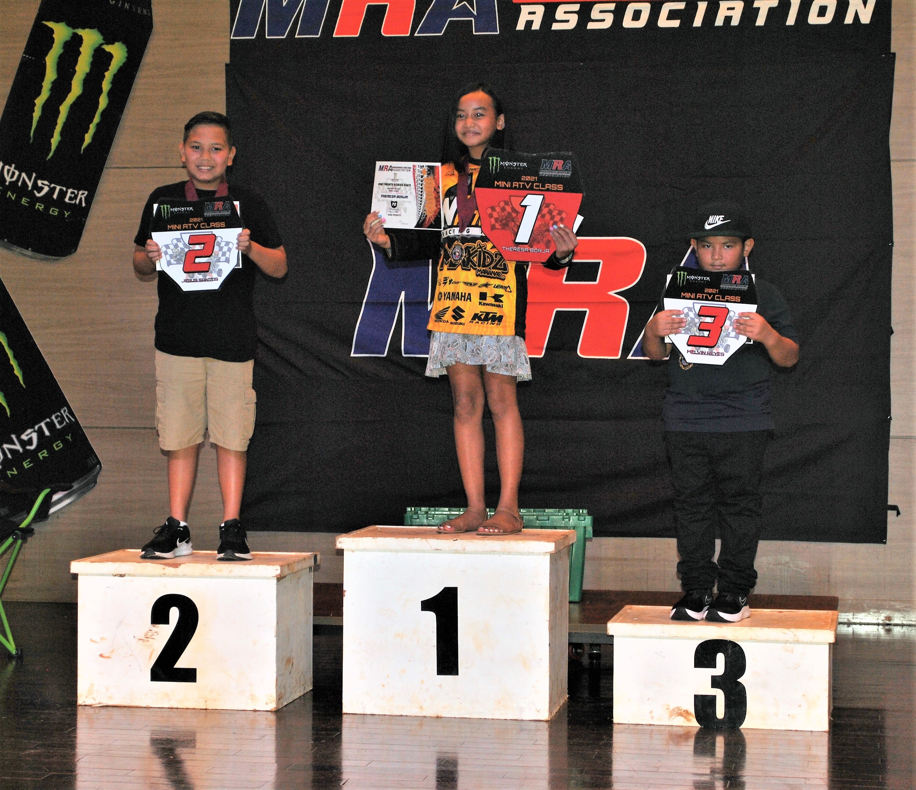 Theresa Borja, center, Jesus Santos, left, and Melvin Reyes, pose with their Mini ATV placement trophies during the awards banquet Wednesday in the Taga Hall of Saipan World Resort.
