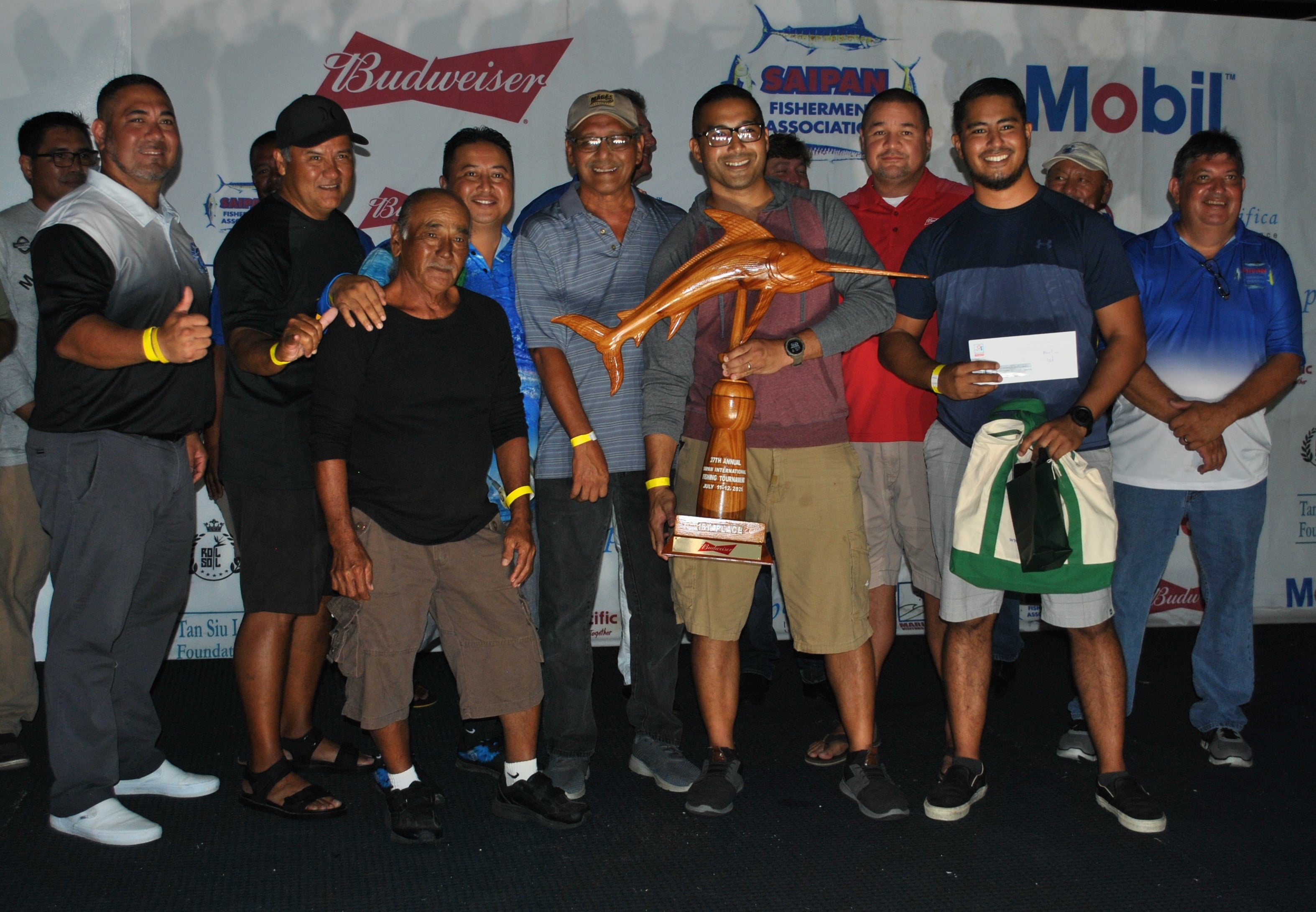 The crewmembers of Defiance pose with the Billfish trophy.