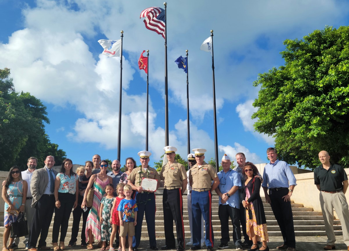 Family, friends, and colleagues join Lt. Col. Albert S. Flores Jr. for a commemorative group photo.