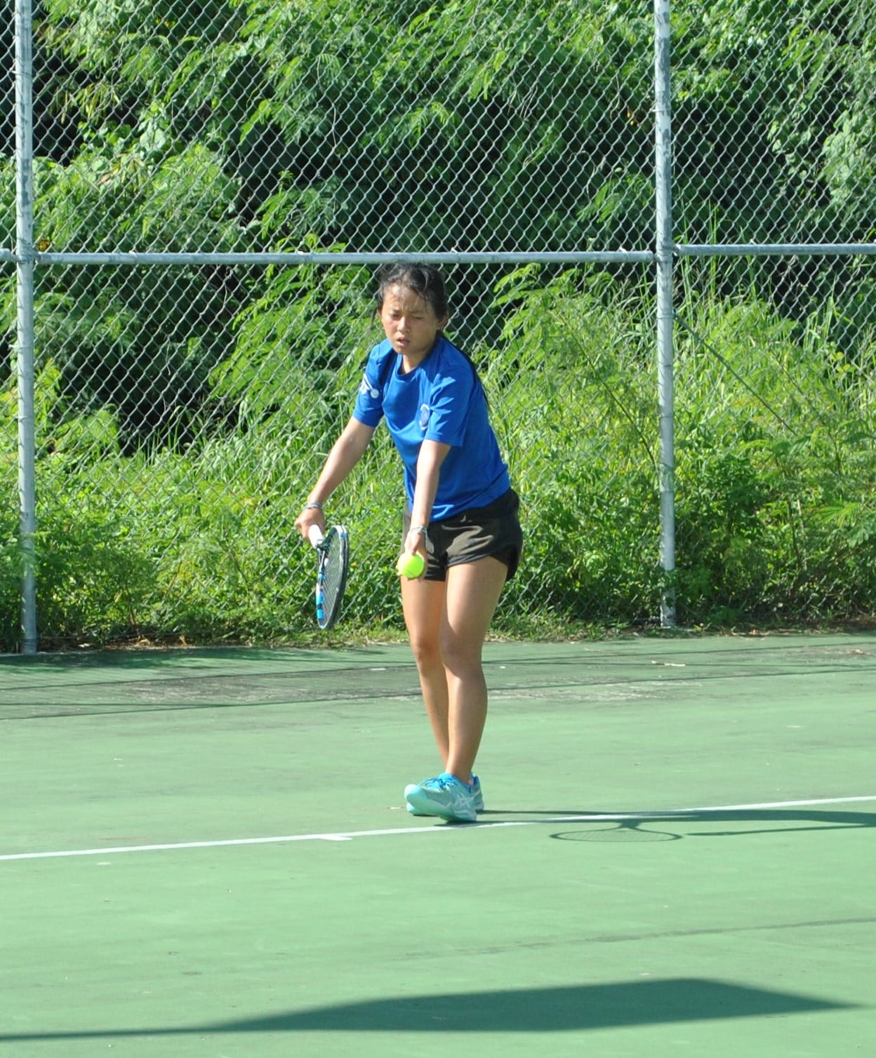 Malika Miyawaki preps her serve.