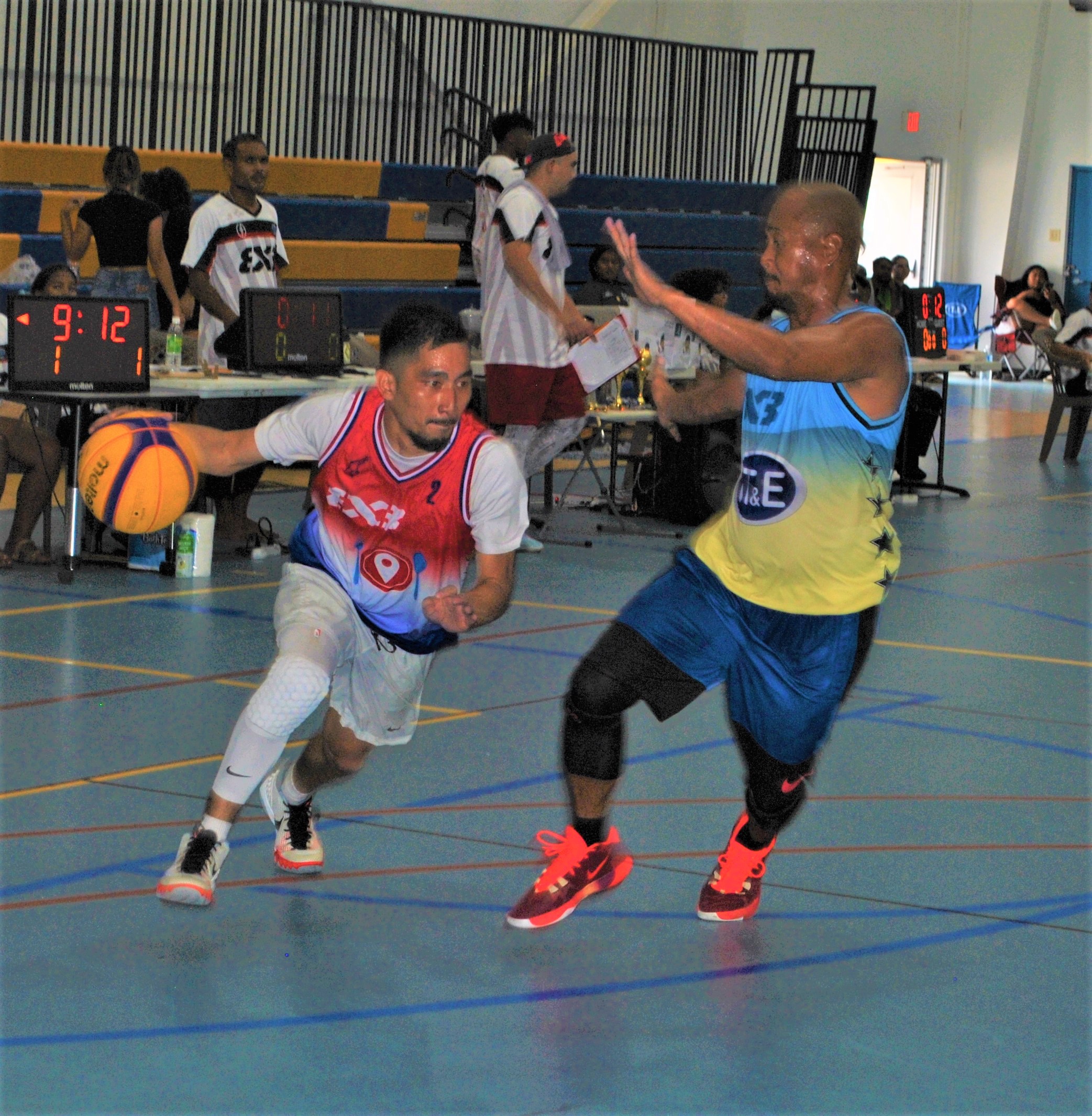 Hole in the Wall's Joe Sablan attempts the drive against Elmer Esdrelon.