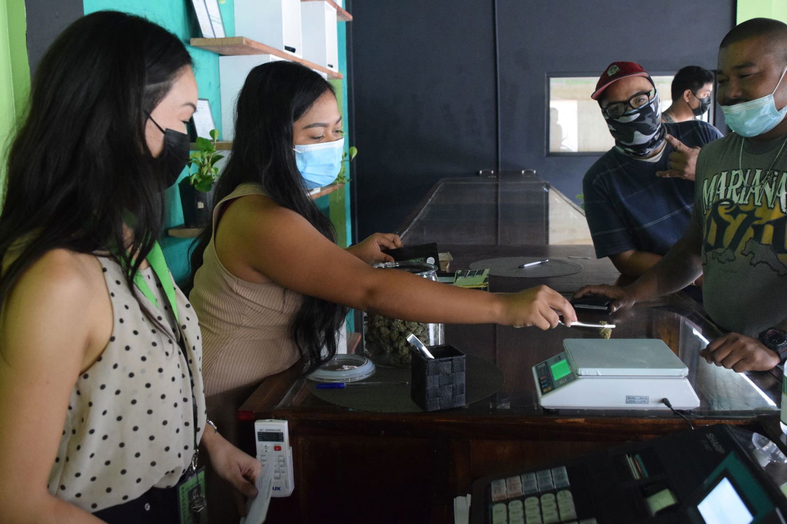 Saipan Select retail staff members attend to customers. 