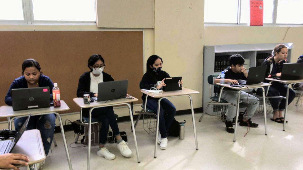 Boot-camp participants attend their online NMC class before working on their sales pitch.