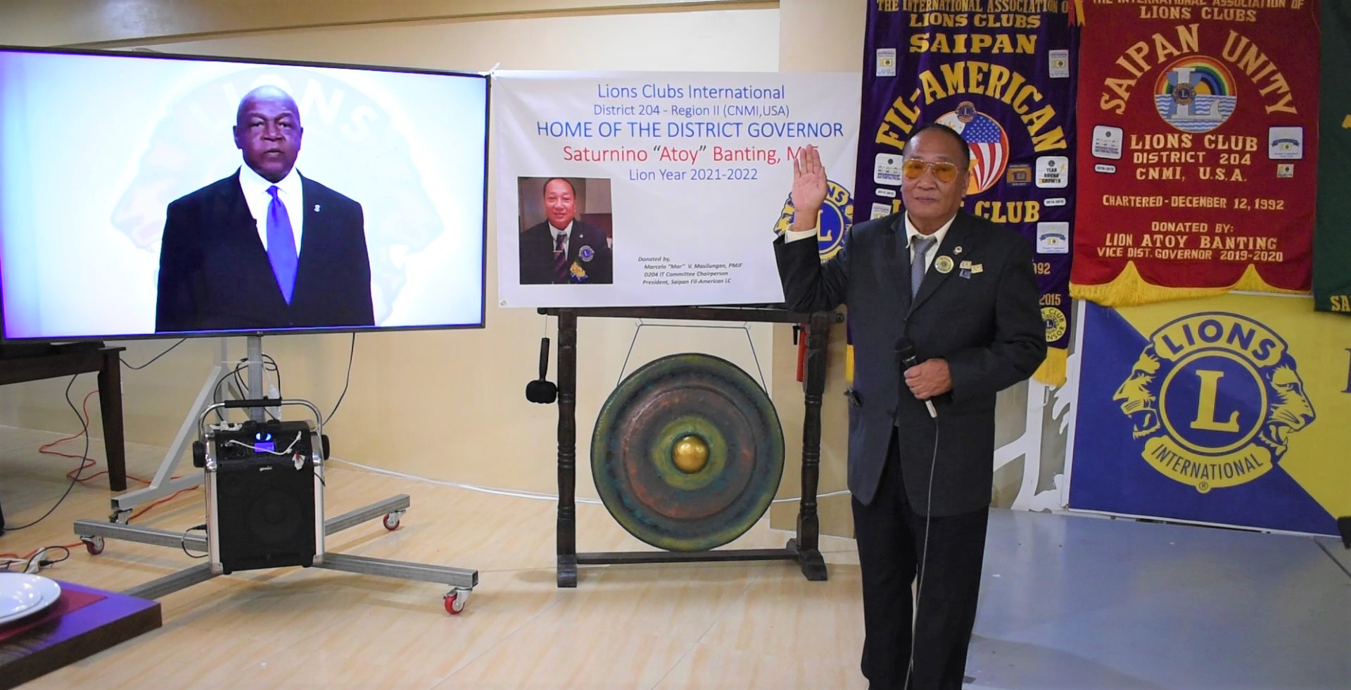 Lions Club International District 204 Gov.  Saturnino “Atoy” Banting with  Lions Club International President Douglas Alexander on the screen.