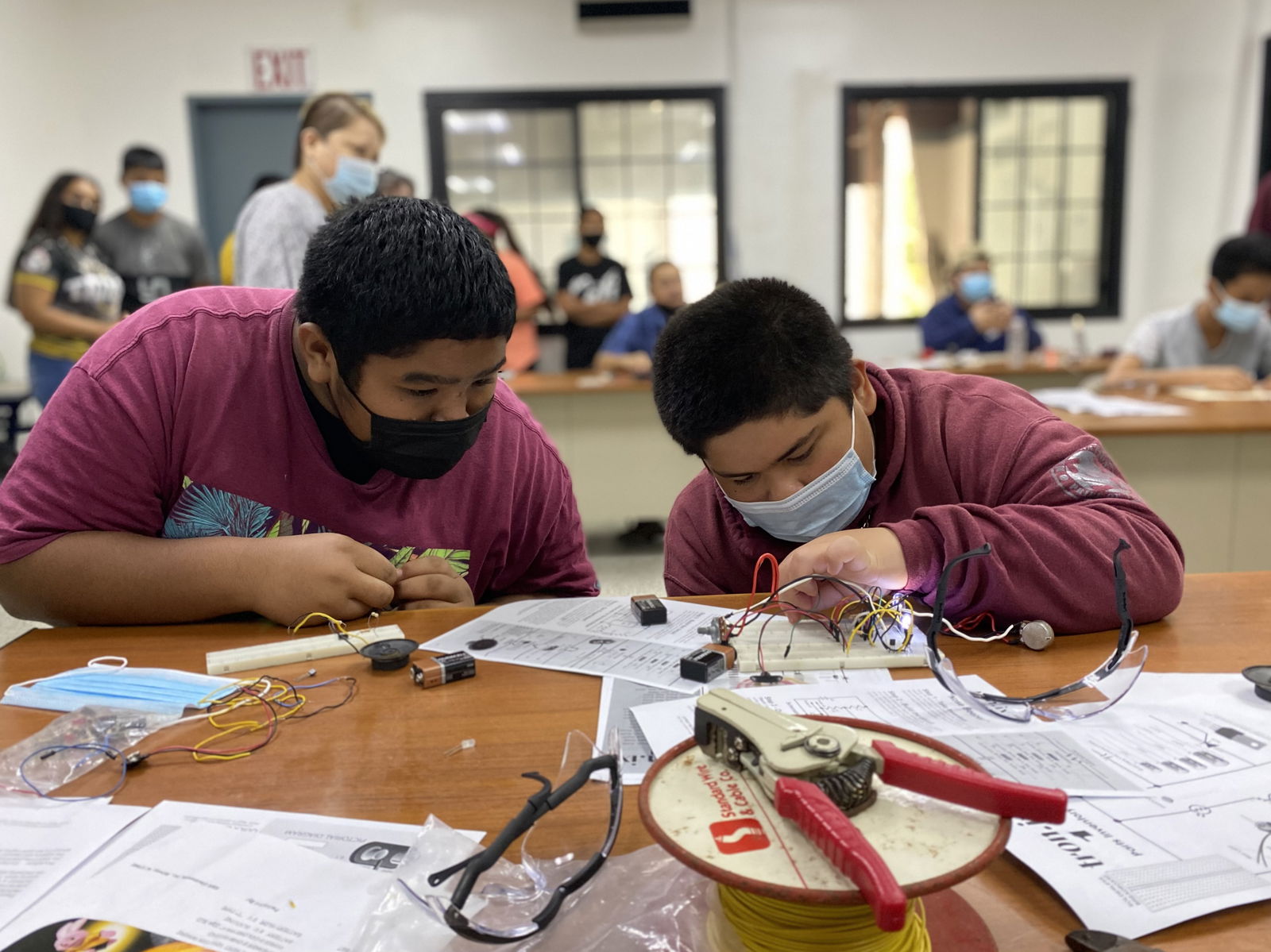 Students learn how to safely use a soldering iron, tweezers and clamps.