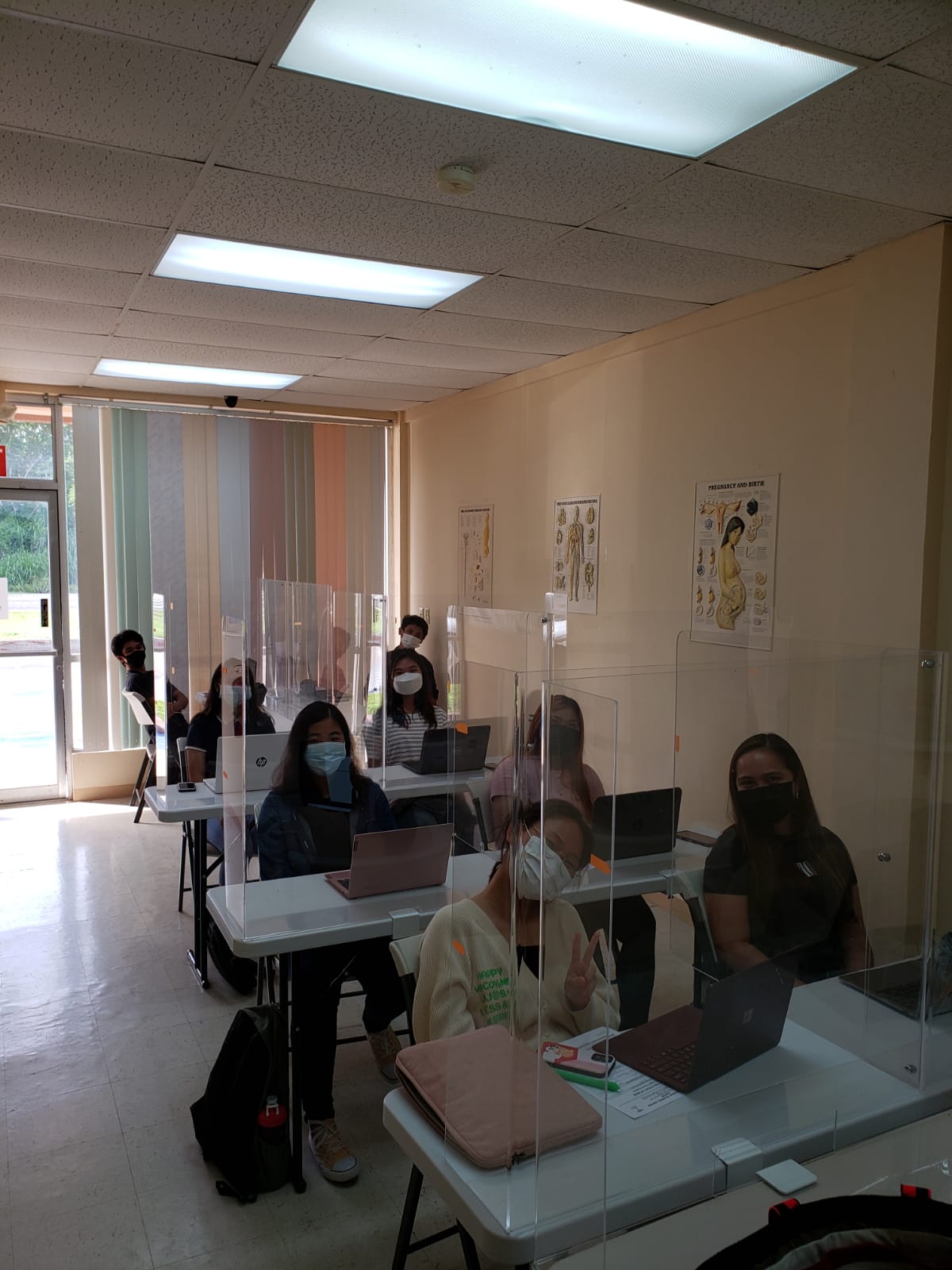 The students attend their online class in a room that complies with  social distancing and other Covid-19 safety measures.