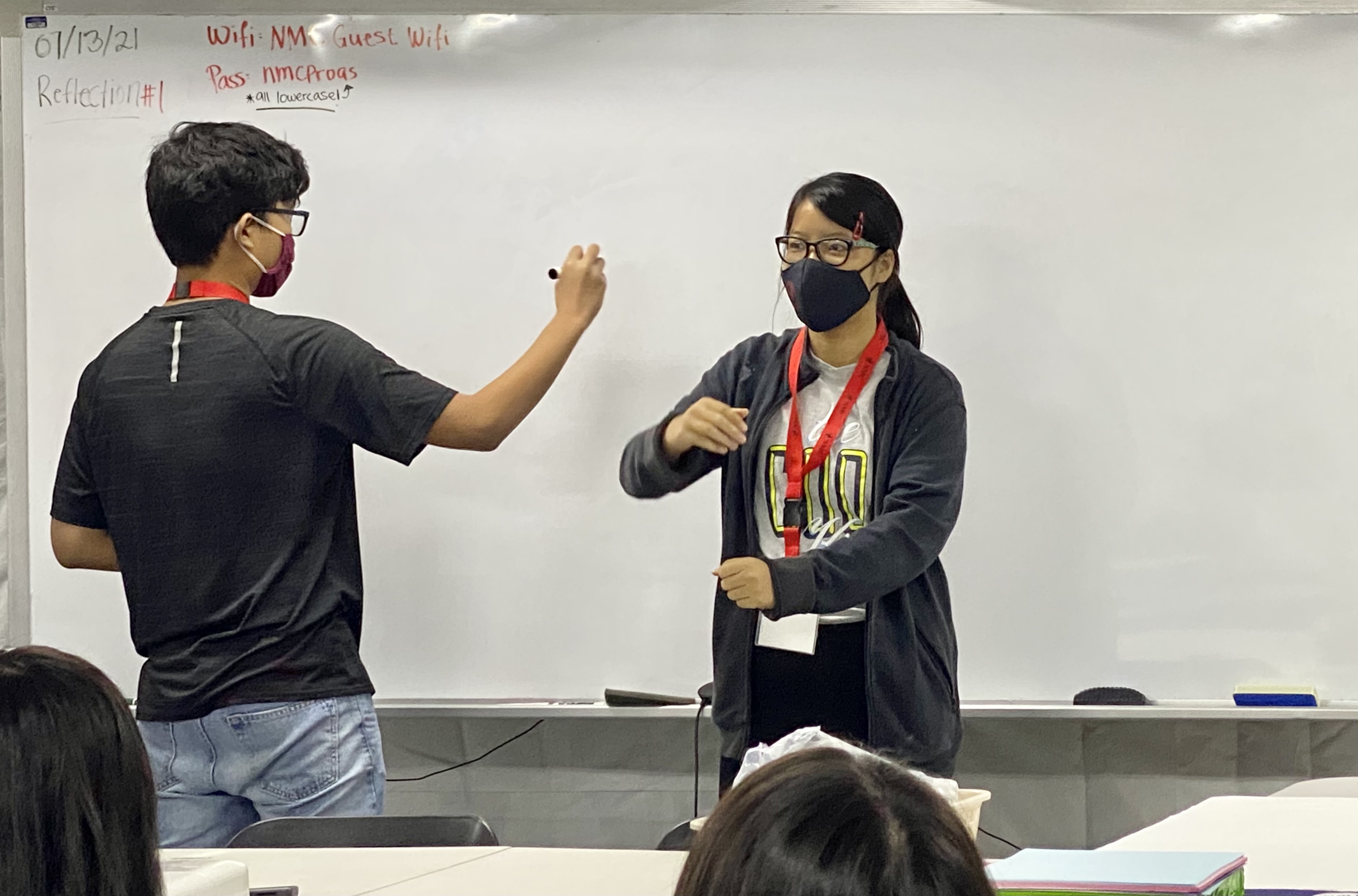 Two students perform an activity.