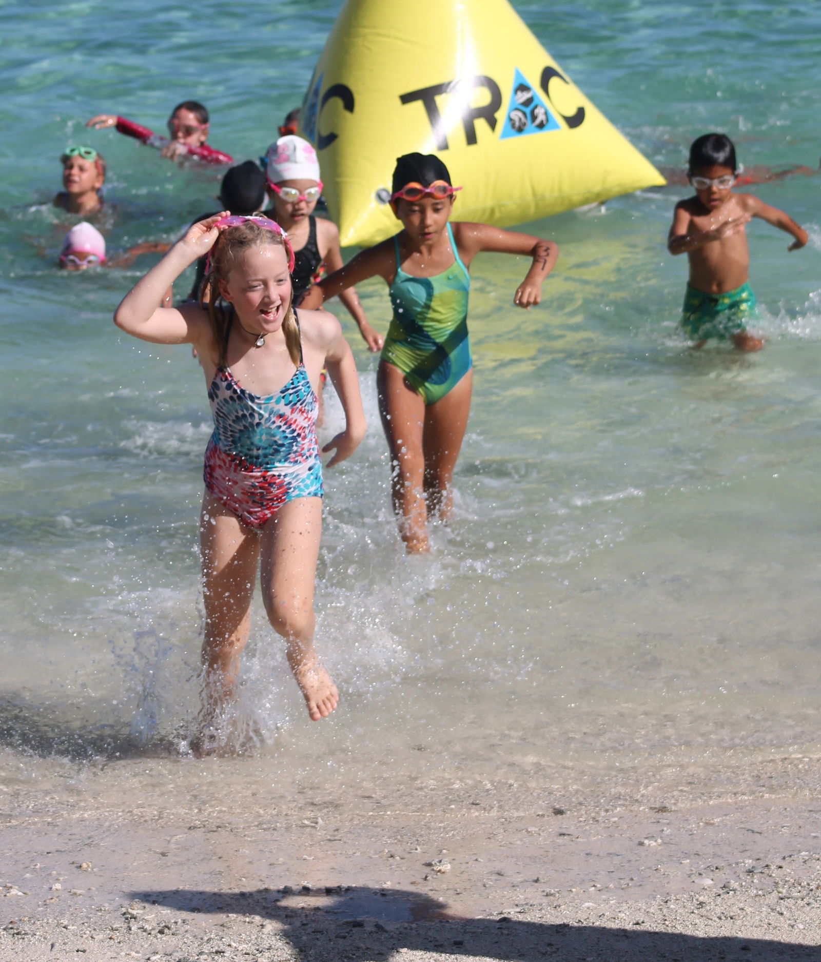 The young athletes rush to transition to the bike leg of the Taga Kids 2021 on Saturday at Paupau Beach.