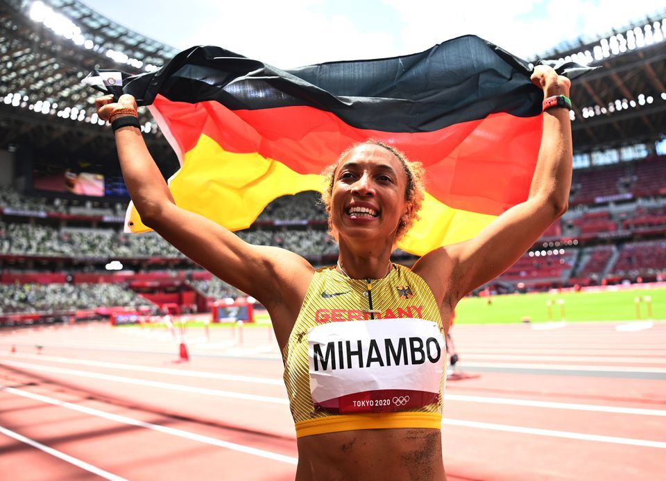 Malaika Mihambo of Germany celebrates with her national flag after winning gold in the women's long jump at the Olympic Stadium in Tokyo, Japan on Tuesday.