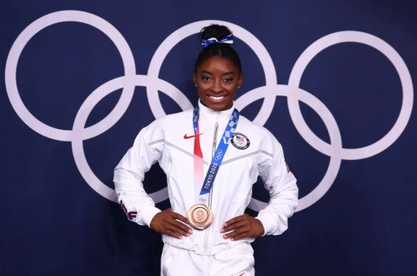 Bronze medalist Simone Biles of the United States poses in front of the Olympic rings at the  Ariake Gymnastics Center in Tokyo, Japan on Aug. 3, 2021.