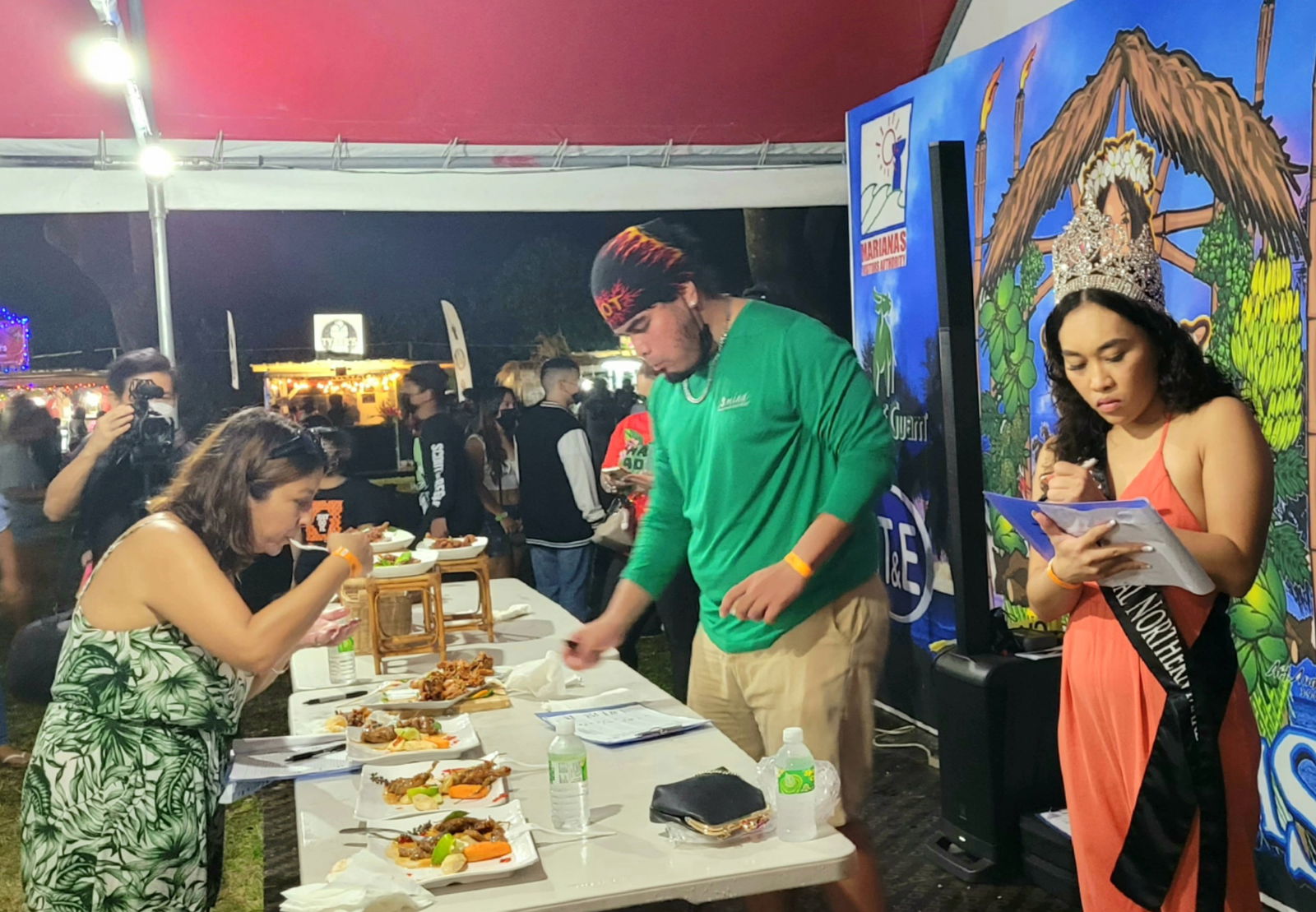 Judges taste the dishes in the Kadun Pika cooking contest.