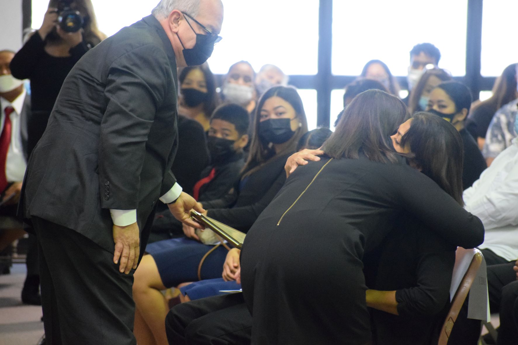 U.S. Congressman Gregorio Kilili Camacho Sablan looks on as his wife Andrea embraces Rep. Ivan Blanco's widow, Carmen Sablan. Kilili also handed a framed tribute to the late lawmaker’s family.