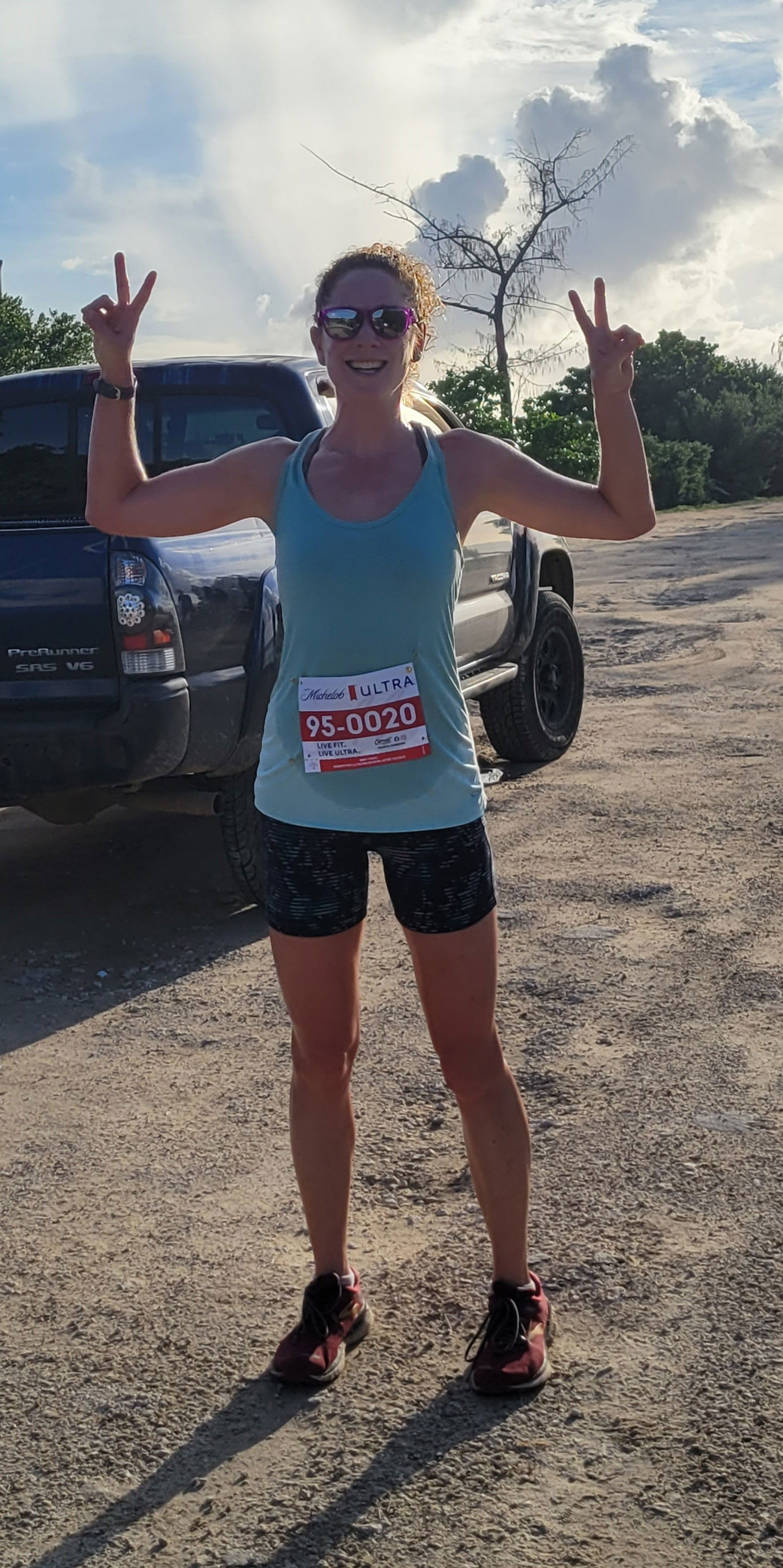 Lily Muldoon poses after finishing first in the Michelob Ultra 4-Mile Run for Taste and Pokka 4-Mile Sunset Run on Saturday at the Garapan Fishing Base.