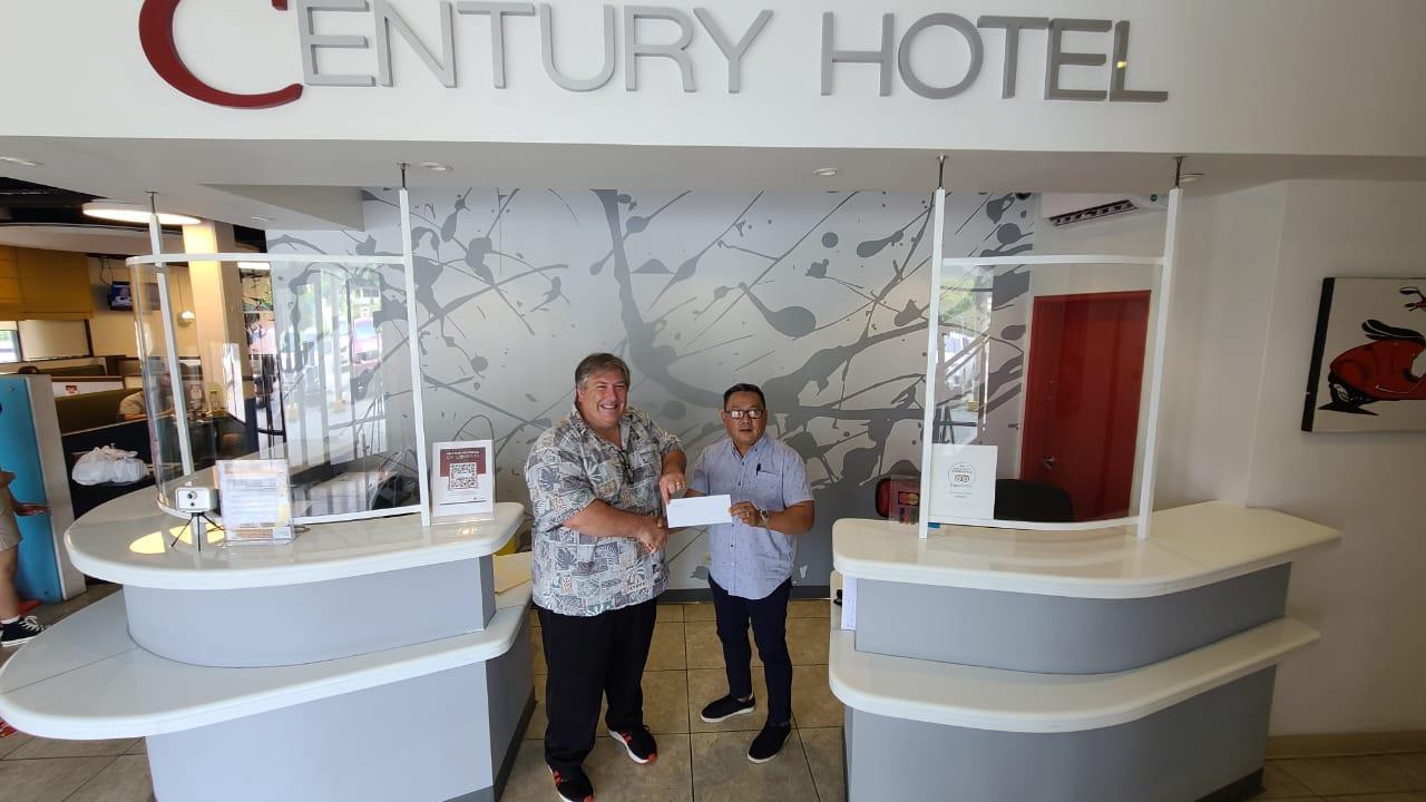 Century Hotel general manager Ivan Quichocho, right, donates $200 to the 19th Annual HANMI Charity Classic Golf Tournament which will be held on Aug. 14, 2021 at Coral Ocean Golf Resort.  Also pictured is tournament committee chairman Glenn Policare.