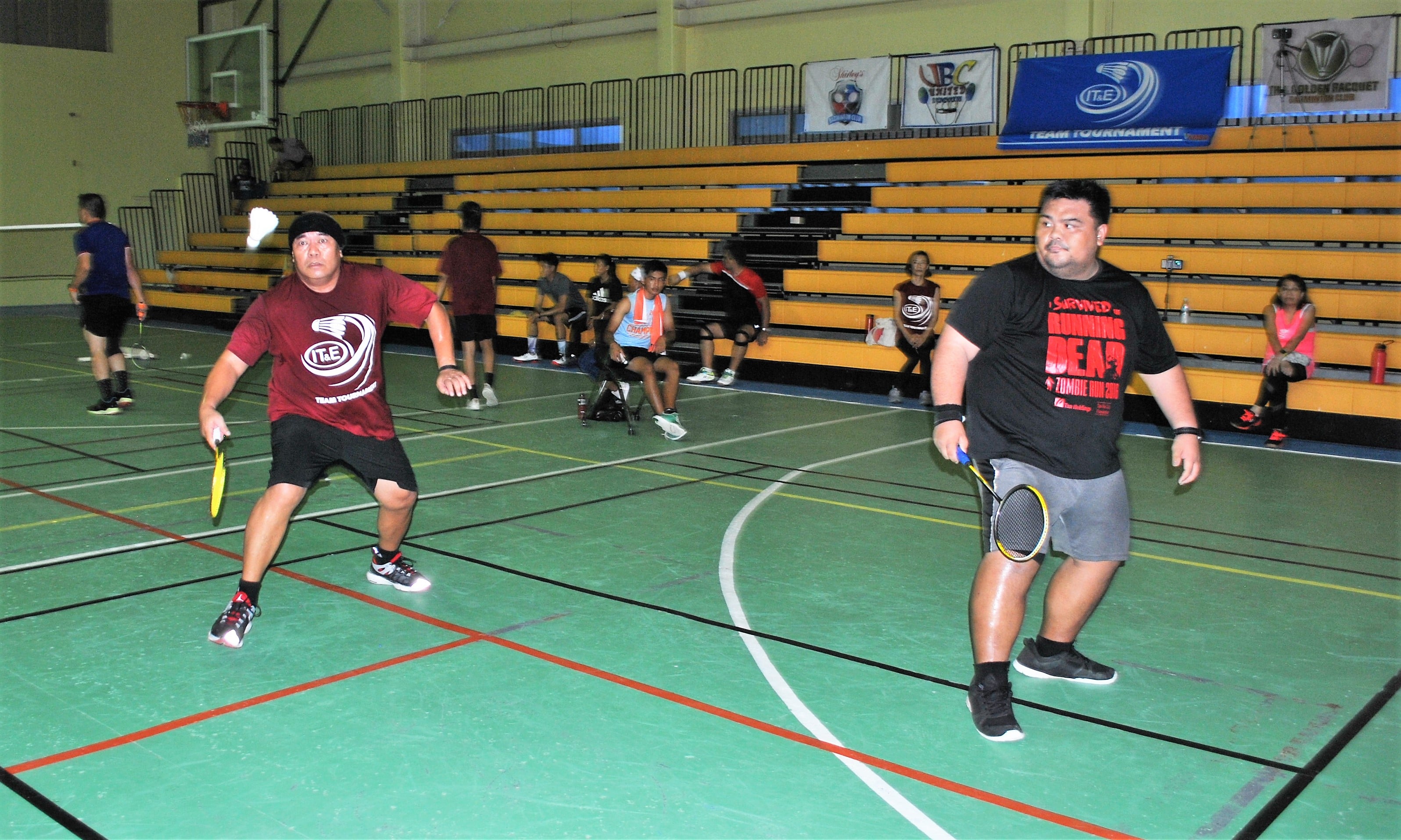 Shirley's Alvin Alvarez attempts the forehand return as teammate PatJake Fieldad looks on during an IT&E Badminton Tournament game Saturday at the Ada gym.