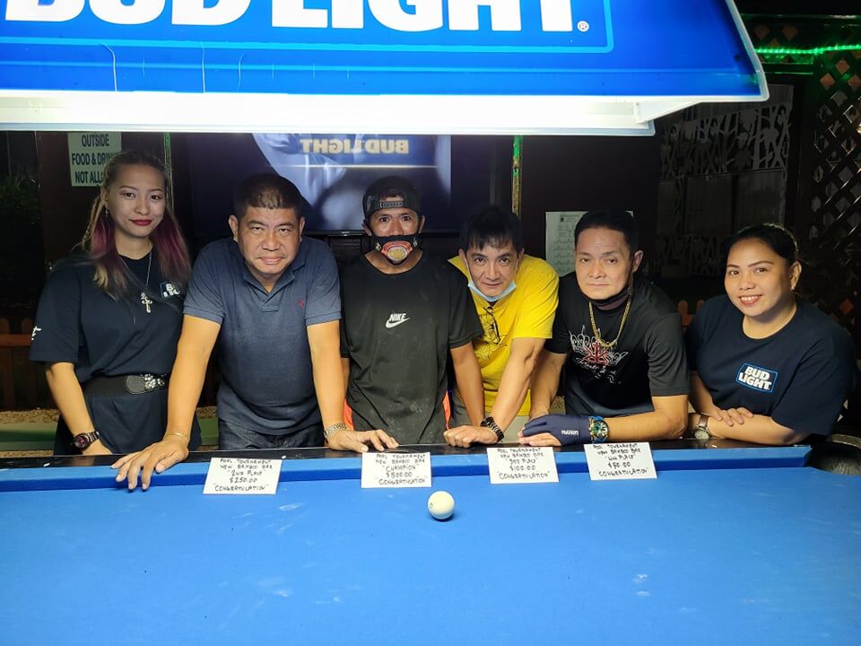 Jess Farinas, third left, poses with Jerry Soriano, second left, Cesar Sangalang, third right, Rey Hermogenes, second left, and the New Bamboo Bar staff following the July New Bamboo 8 Ball Tournament at Saipan Vegas.