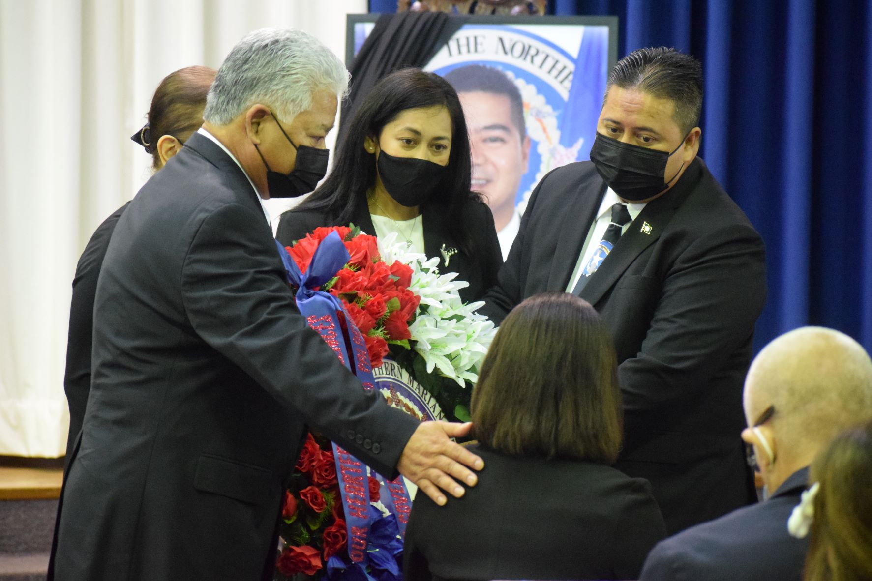 Gov. Ralph DLG Torres and Lt. Gov. Arnold I. Palacios present a state wreath to the family of Rep. Ivan Blanco. Also in the photo is first lady Diann T. Torres, center.