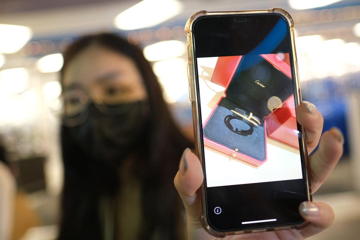 May Tu, a tourist from Taiwan, displays a picture of her Cartier bracelet that she left in a changing room at Ross Dress for Less in Tamuning. Store employees found the bracelet and returned it to Tu.