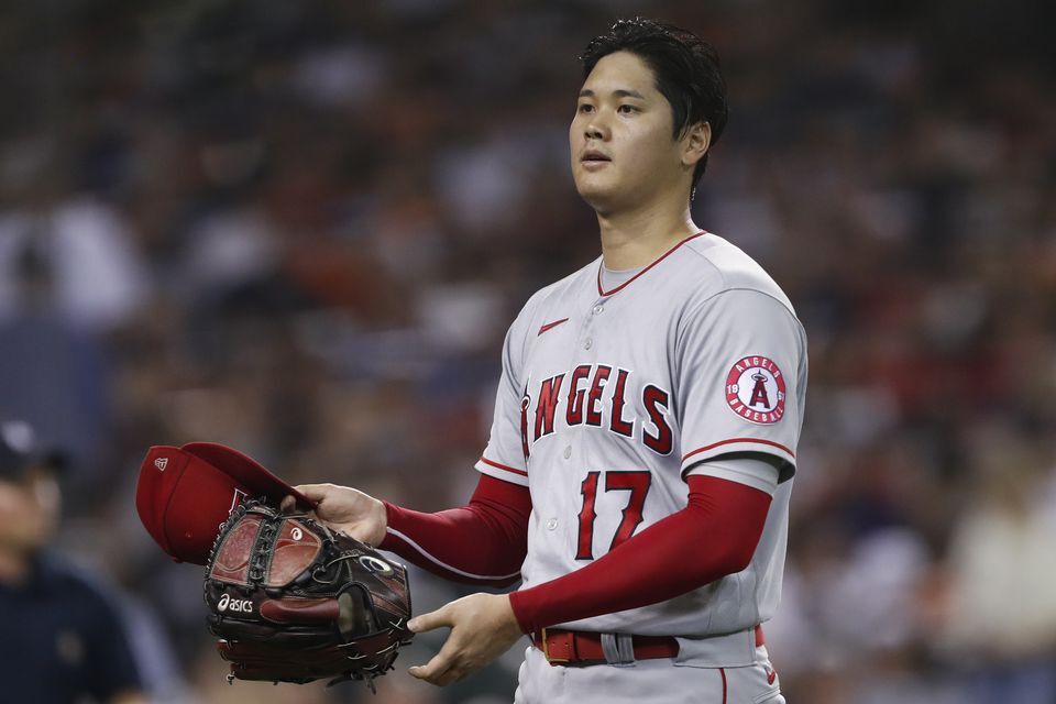 Los Angeles Angels starting pitcher Shohei Ohtani (17) prepares to give his equipment to an umpire during the seventh inning against the Detroit Tigers at Comerica Park in Detroit, Michigan on Aug. 18, 2021.