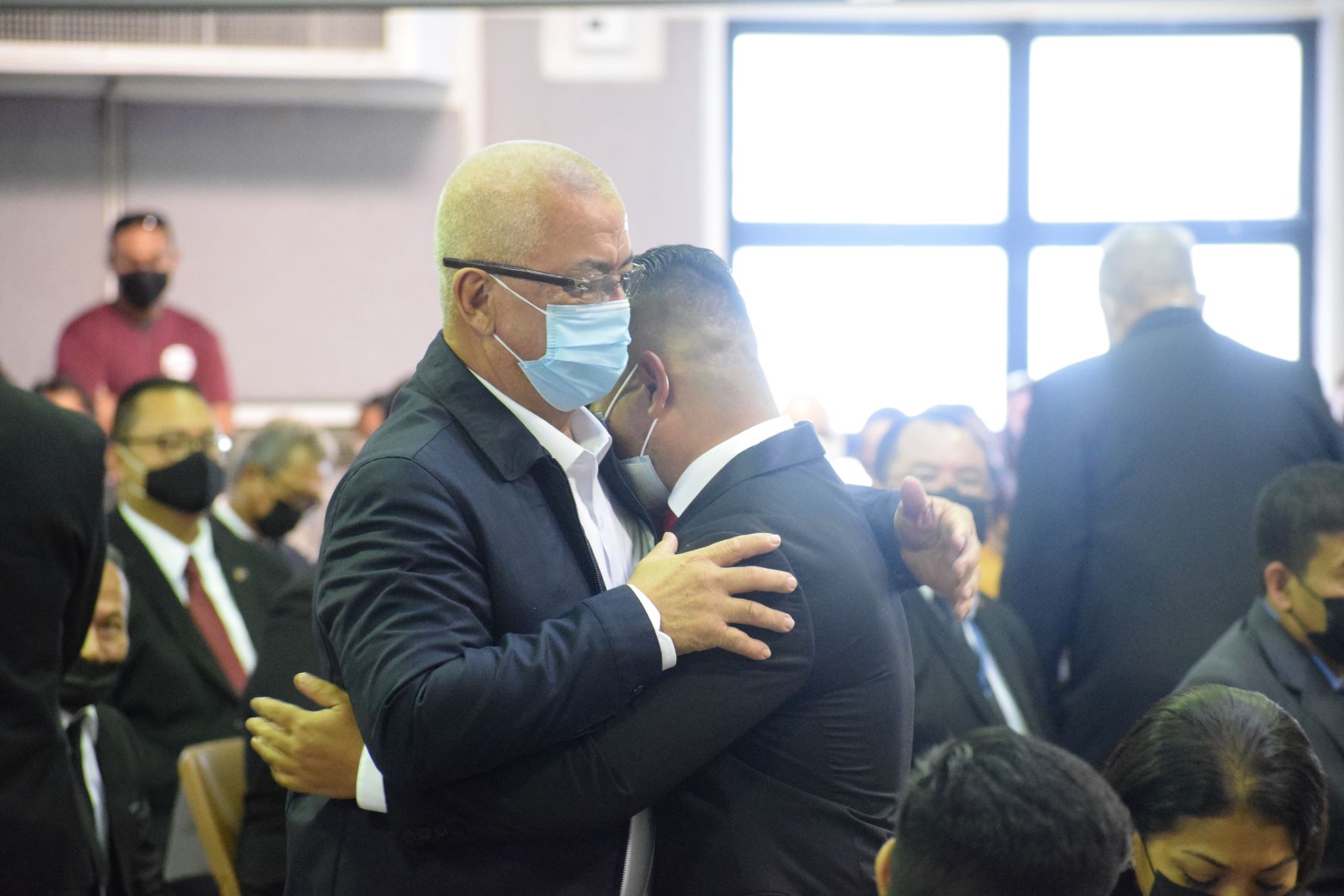 Rep. Joel Camacho cries on the shoulder of Rep. Ivan Blanco's father, Diego.