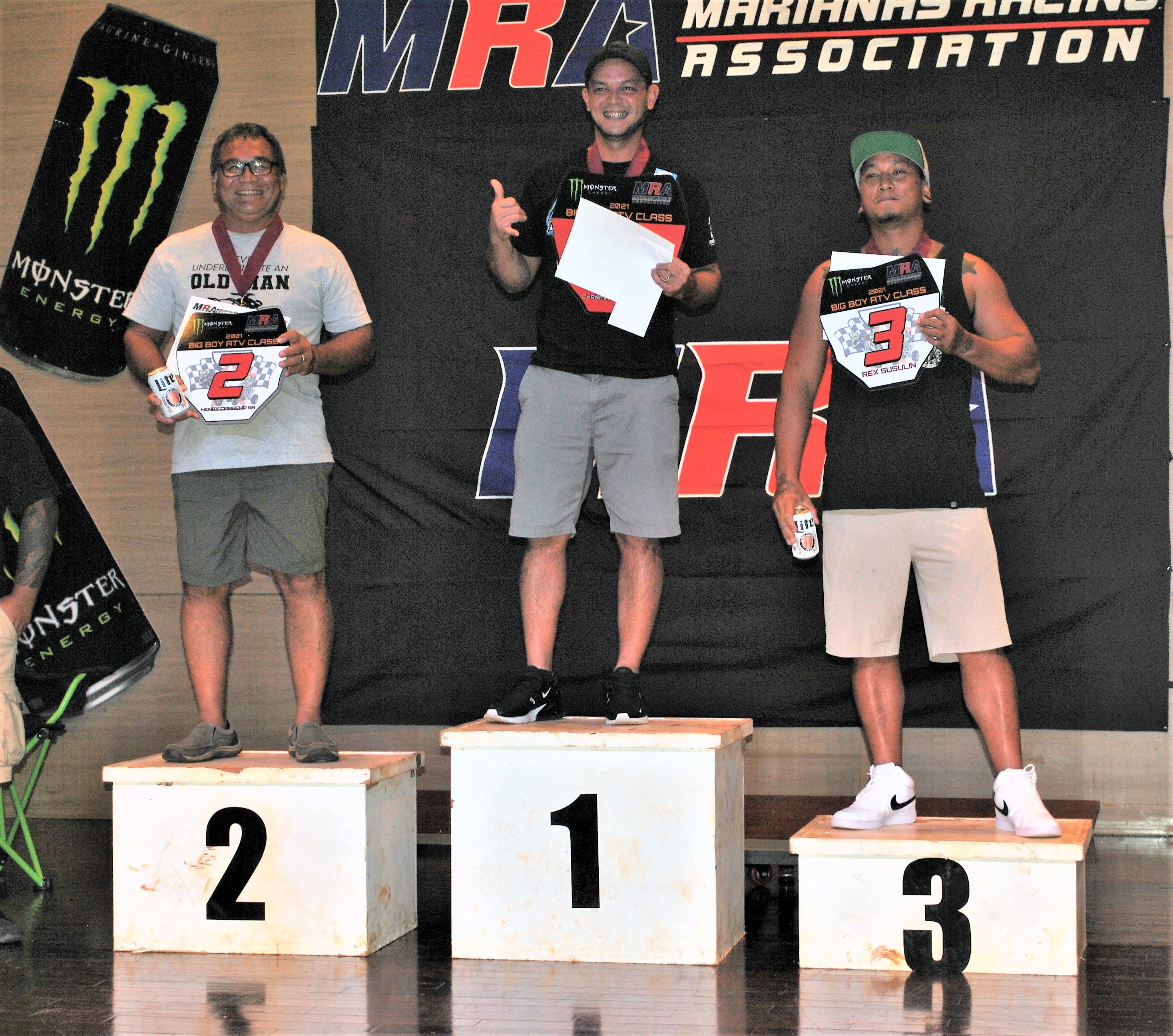 Christian Camacho, center, smiles as he poses for a photo with his Red Plate trophy during the awards banquet of the Marianas Racing Association 2021 Points Race Series at the Saipan World Resort Taga Hall. Henry Camacho Sr., left, finished second while Rex Susulin, right, was third.