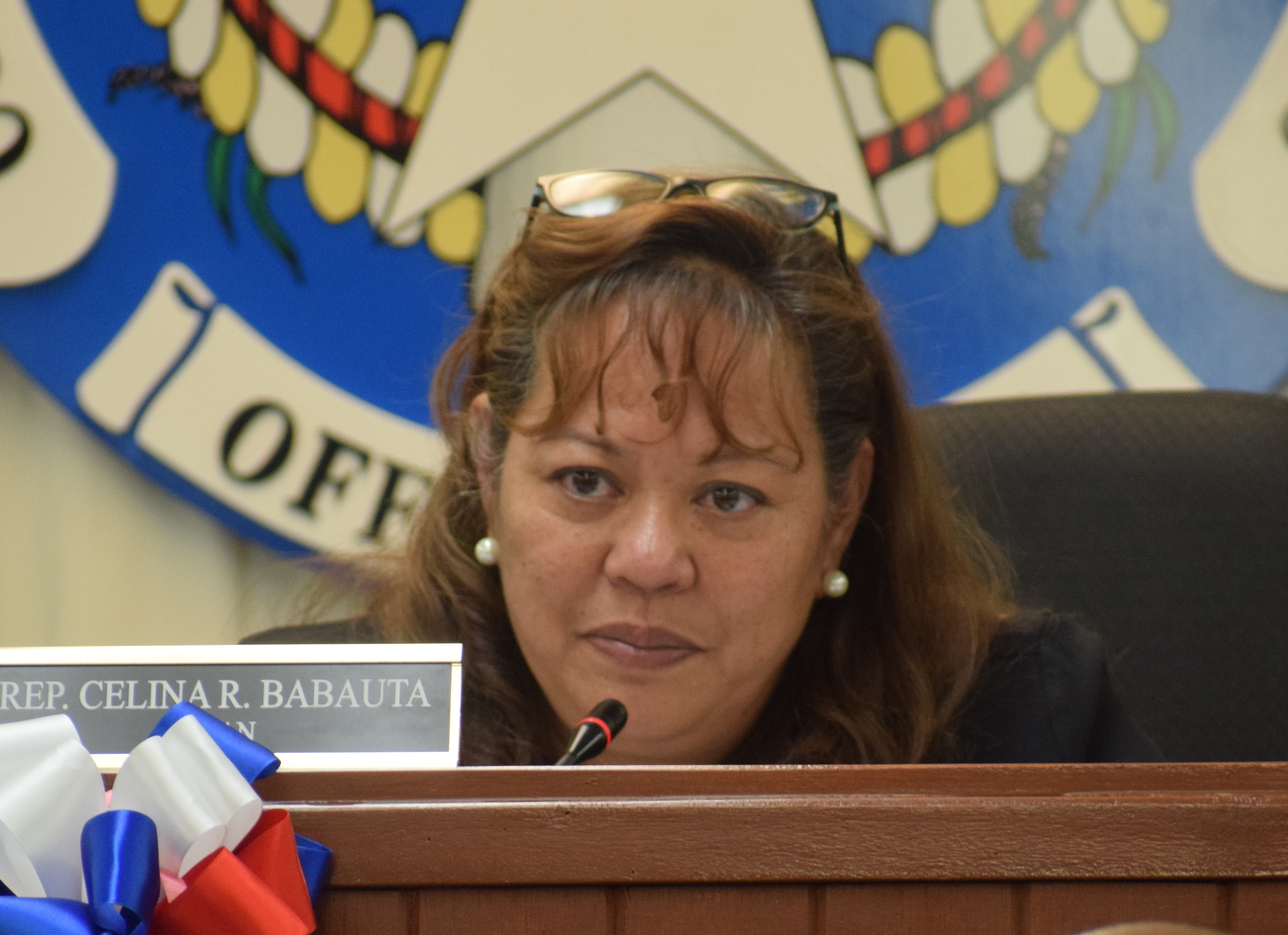 The chairwoman of the House Judiciary and Governmental Operations Committee, Celina R. Babauta, presides over a hearing in the House chamber.