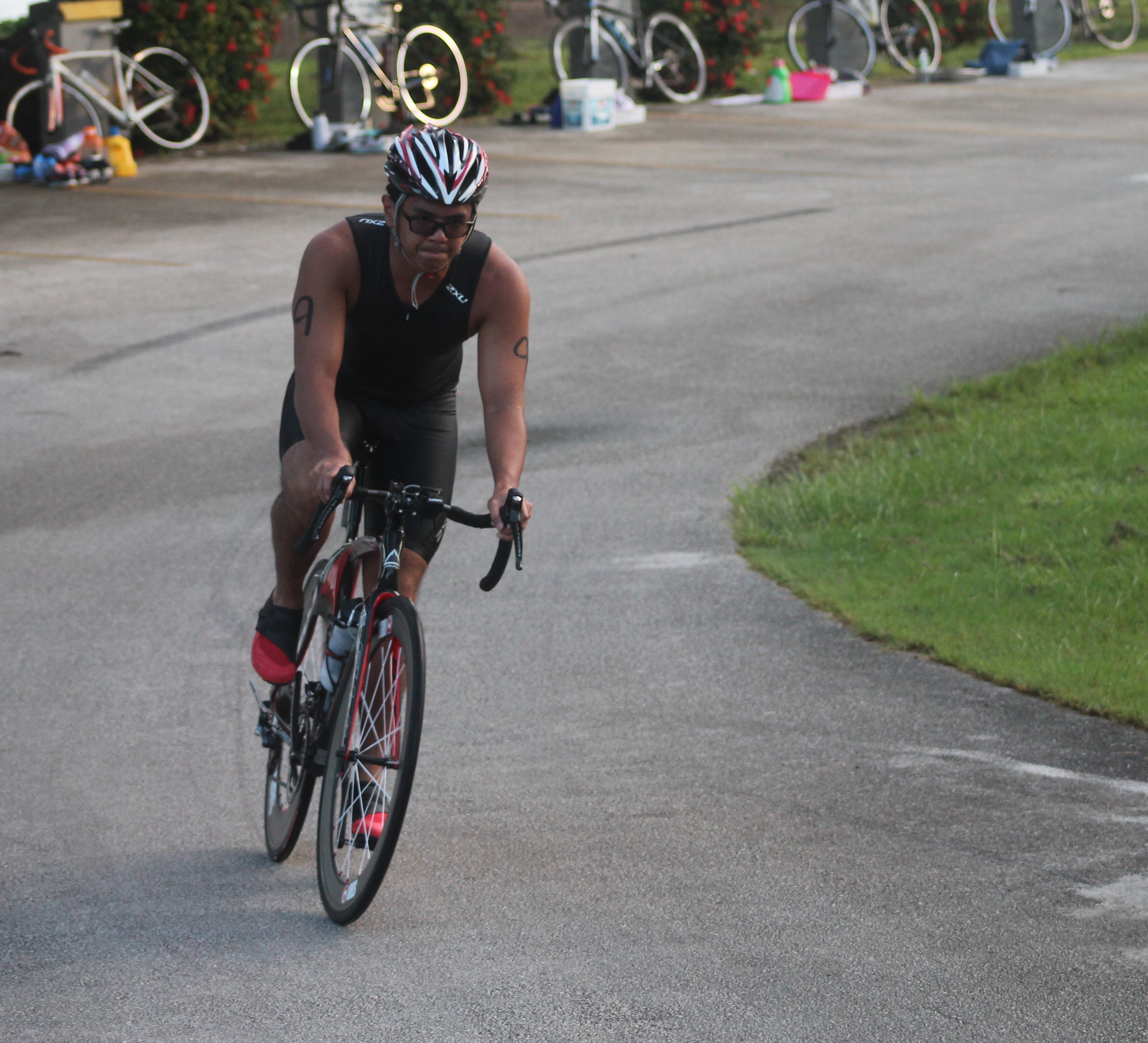Christian Villacrusis makes a turn during the bike leg of the Tri Team tryout at Paupau Beach on Saturday.