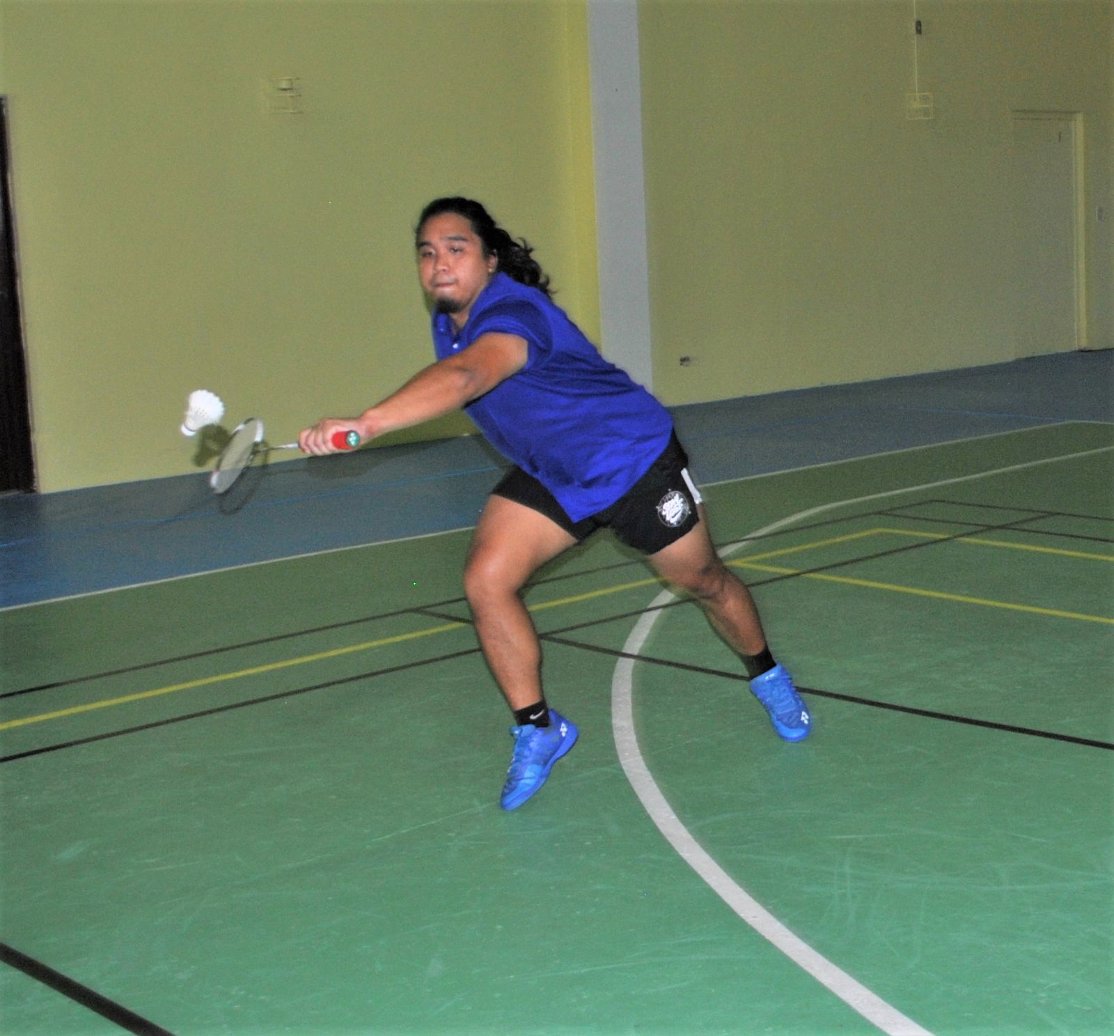UBC's Ezekiel Macario extends for a backhand return during  an A Men's Doubles game of the IT&E Badminton Tournament on Saturday at the Ada gym.