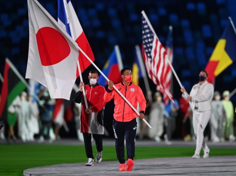 Flag bearer Ryo Kiyuna of Japan marches with the other athletes during the closing ceremony at the Olympic Stadium, Tokyo, Japan on Aug. 8, 2021.