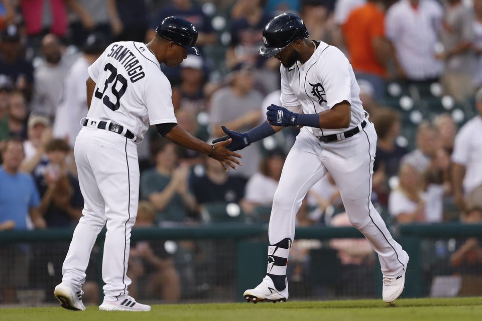 Detroit Tigers left fielder Willi Castro (9) celebrates with third base coach Ramon Santiago (39) after hitting a solo home run against the Los Angeles Angels during the fifth inning at Comerica Park in Detroit, Michigan on Aug. 18, 2021.