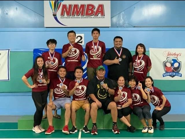 Shirley's Badminton Club members pose with their first-place medals during the awards ceremony Saturday at the TSL Multi-Purpose Gym.