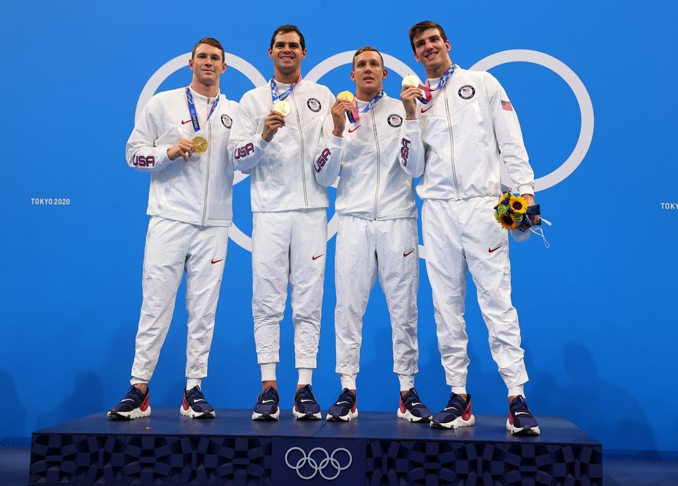 Ryan Murphy, Michael Andrew, Caeleb Dressel and Zach Apple of the United States pose with their gold medals after winning the men's 4 x 100m medley relay at the Tokyo Olympics in Japan on Aug. 1, 2021.
