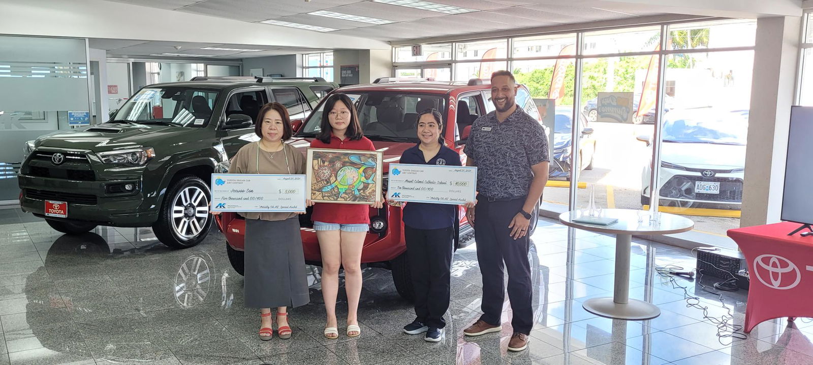 Mount Carmel School’s Jeewoo Son, second left, poses with her artwork and awards,  her mother Juyoung Lee, school vice principal Filmah Buenaflor and AK Saipan sales manager Kevin Barnes.