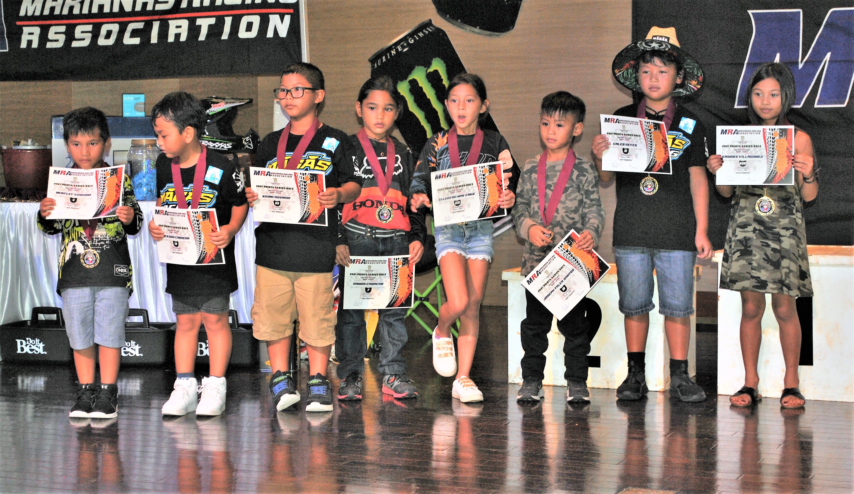 The PeeWee 1 Class ride pose for a photo with their certificates during the awards banquet at Saipan World Resort on July 28.