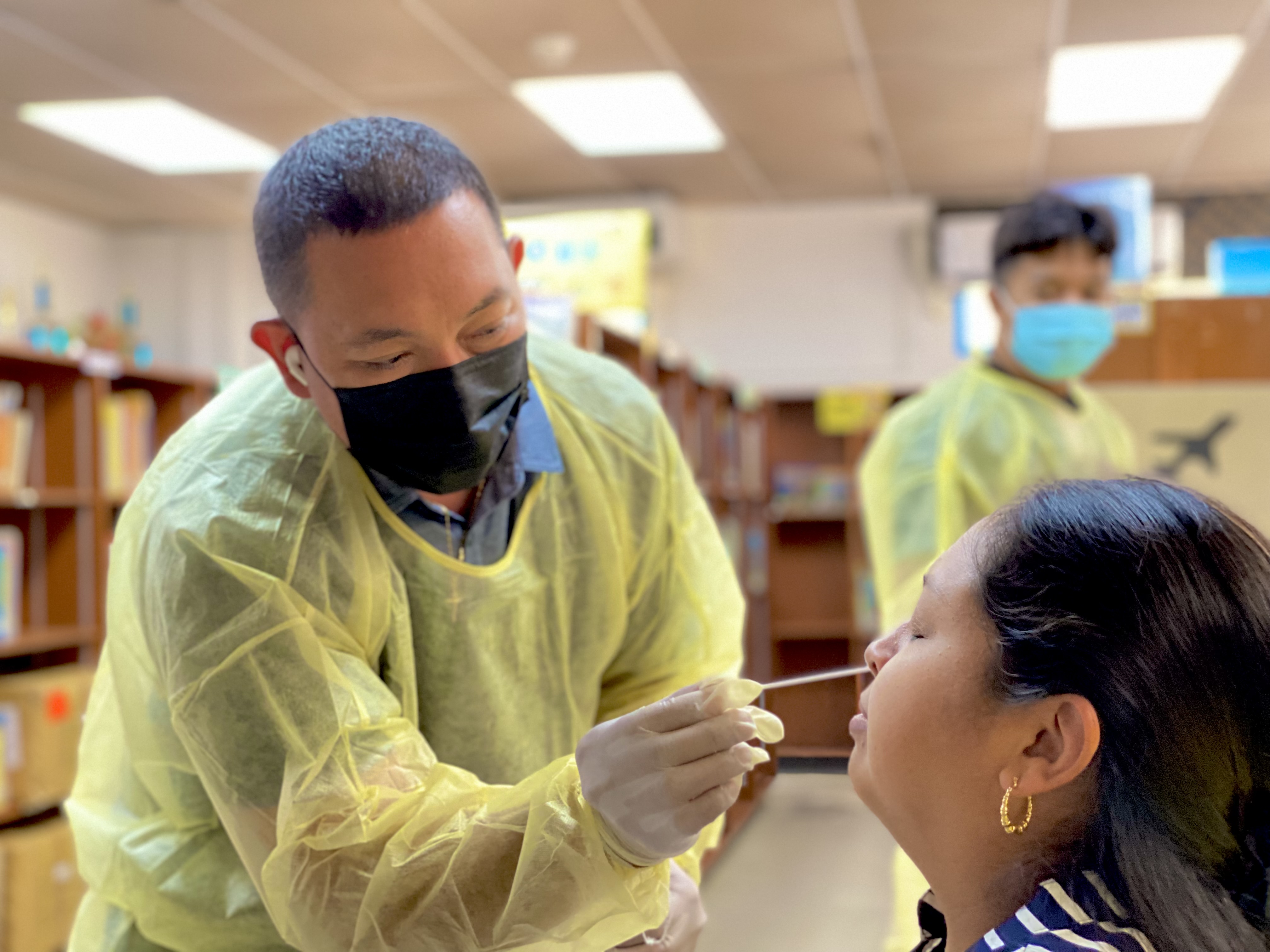 Garapan Elementary School staffer Lauran Matsunaga was among the first to get the antigen test on Wednesday.