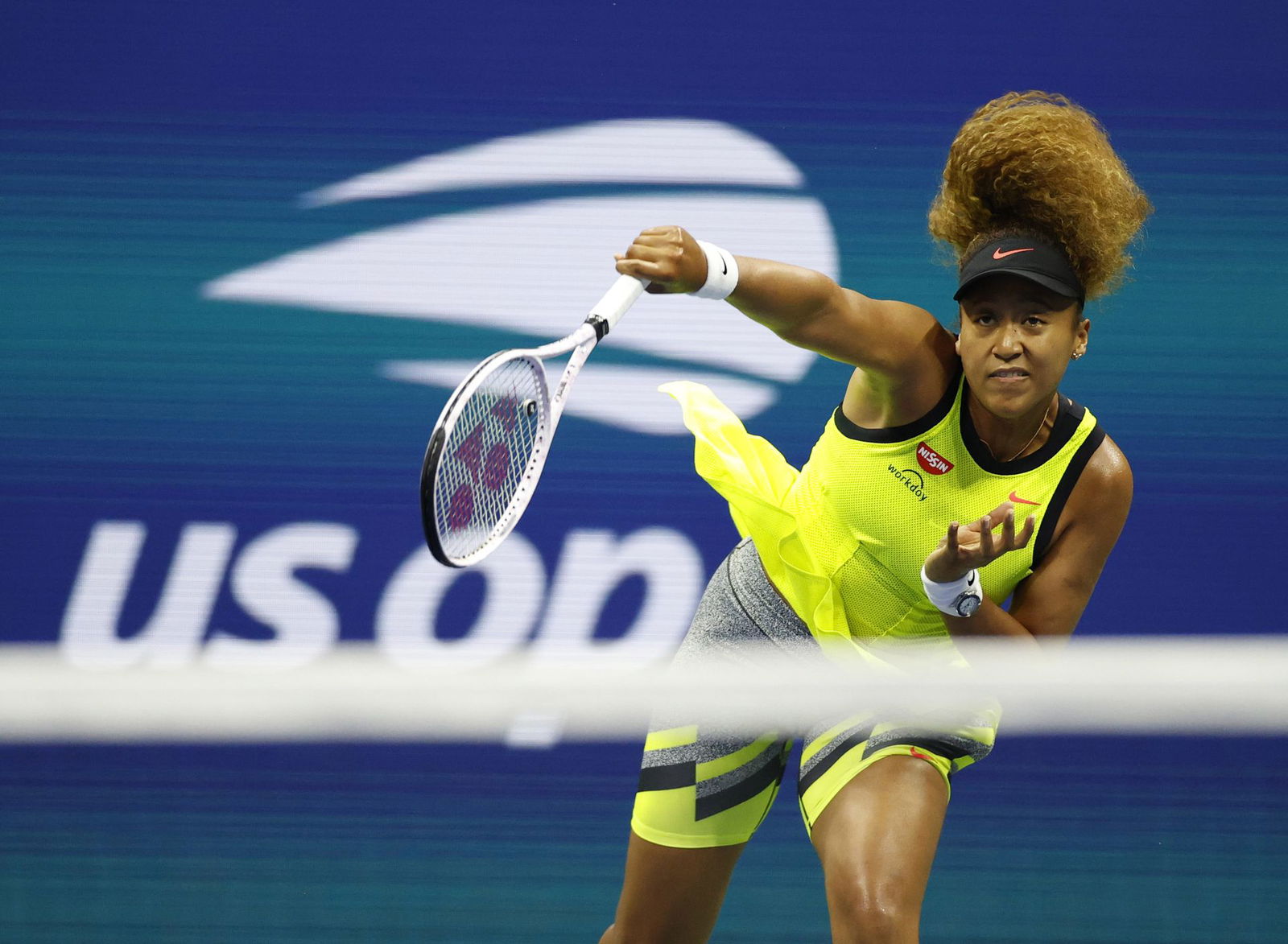 Naomi Osaka of Japan serves against Marie Bouzkova of the Czech Republic in the first round of the 2021 U.S. Open tennis tournament at USTA Billie King National Tennis Center in Flushing, NY on Aug. 30, 2021.