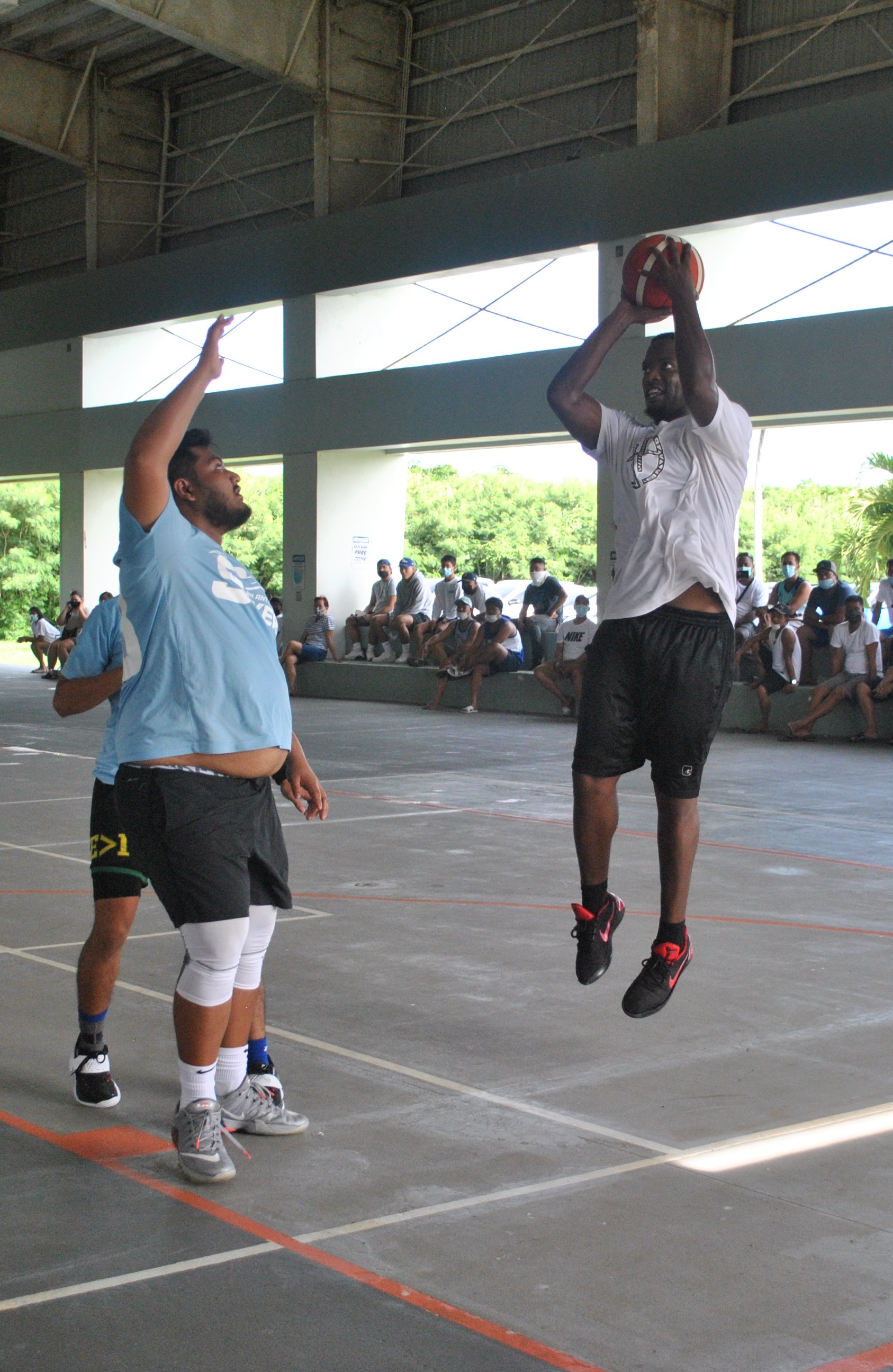 The Game's Eric Joe pulls up for the shot over the Sixers' Jun Javier  during the championship game of the NMI Rollers Basketball Association Men's Tournament at the Koblerville gym on Sunday.