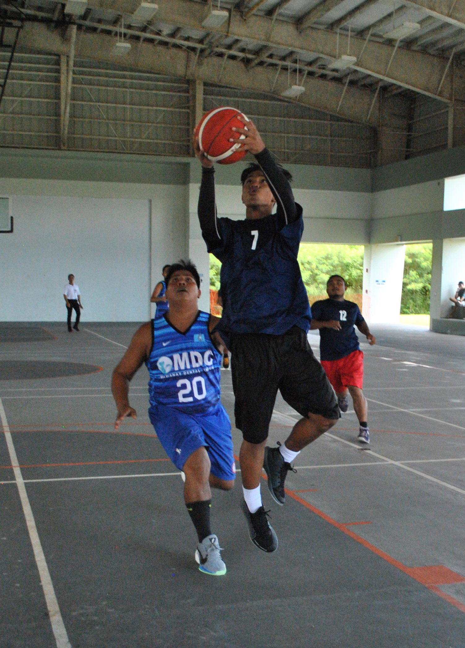 Airson Atan of the Ol'Aces' extends for the finish during a game of the NMI Rollers Basketball Association Men's Tournament on Sunday at the Koblerville gym.