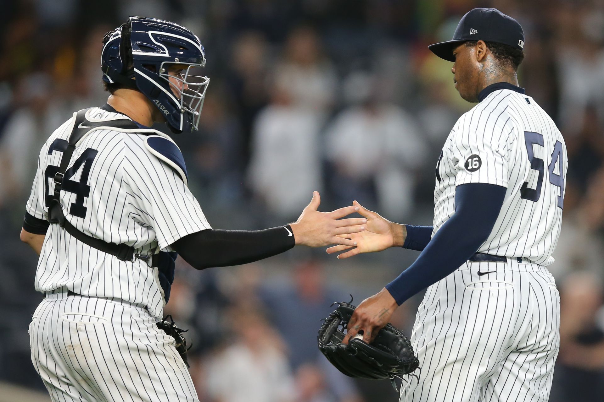 New York Yankees relief pitcher Aroldis Chapman (54) and catcher Gary Sanchez (24) celebrate after defeating the Texas Rangers at Yankee Stadium on Sept. 22, 2021.