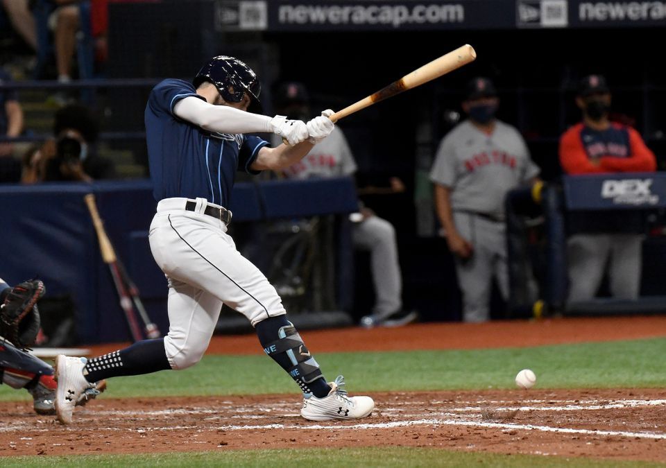 Tampa Bay Rays second baseman Brandon Lowe (8) hits a RBI single in the fourth inning against the Boston Red Sox at Tropicana Field in St. Petersburg, Florida on Aug 30, 2021.