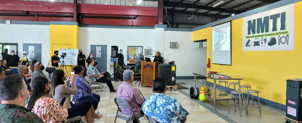 NMTI interim CEO Jodina Attao gives closing remarks as NMTI board members, Gov. Ralph DLG Torres, Lt. Gov. Arnold I. Palacios, House Speaker Edmund S. Villagomez, and other officials and guests look on.