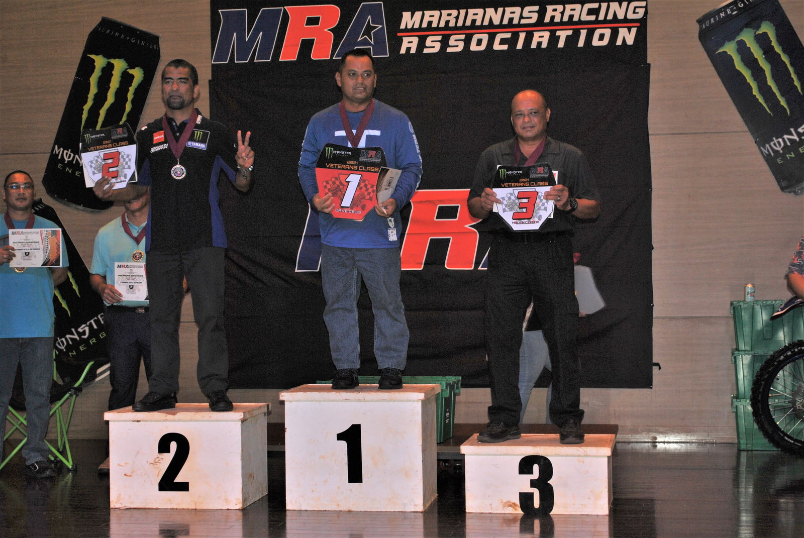 Dave Celis, center, poses with the red plate trophy of the Veterans Class during the Marianas Racing Association 2021 Points Race Series awards ceremony at the Saipan World Resort on July 28, 2021.
