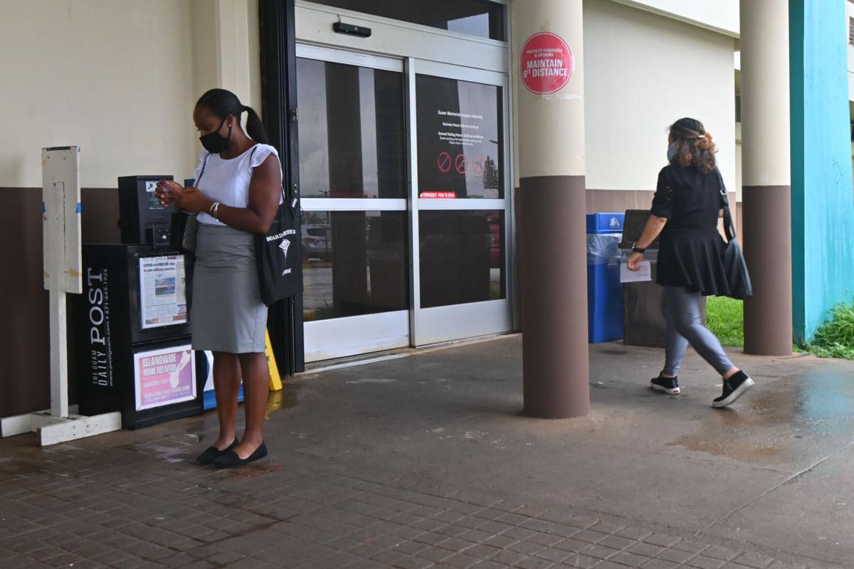A woman, right, is seen entering Guam Memorial Hospital in Tamuning on Aug. 2, 2021.