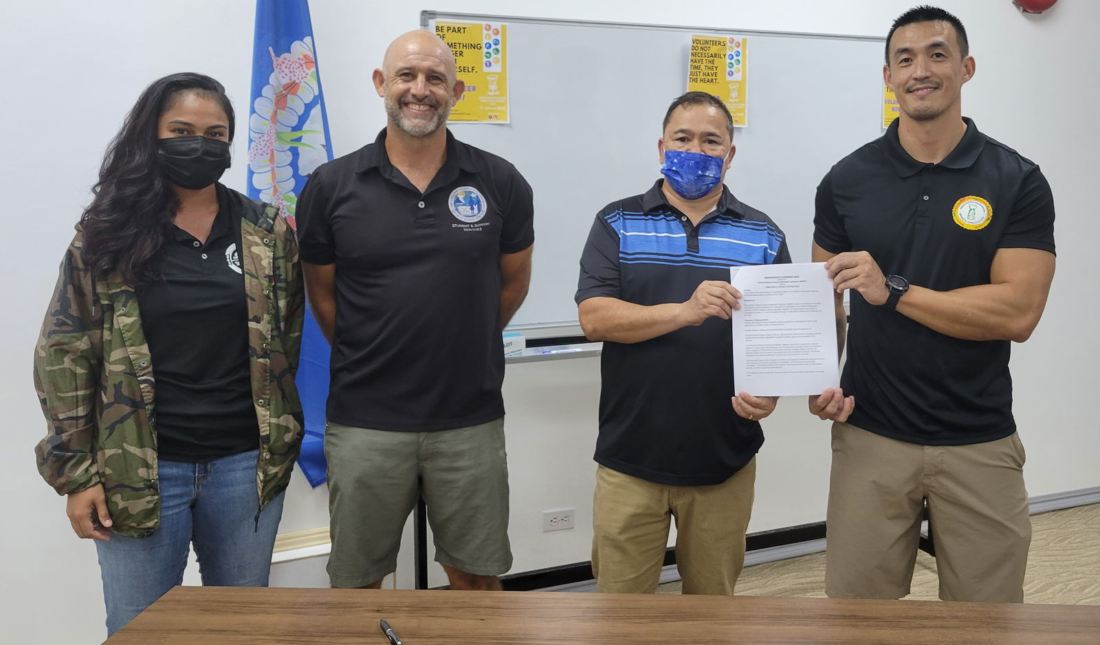 From left, Northern Mariana Islands Basketball Federation director Lia Rangamar, Public School System athletic program director Nick Gross, Education Commissioner Dr. Alfred B. Ada, and NMIBF president James Lee pose for a photo after the memorandum of agreement signing between the NMIBF and PSS for the 2021-2022 season of the interscholastic basketball competition.