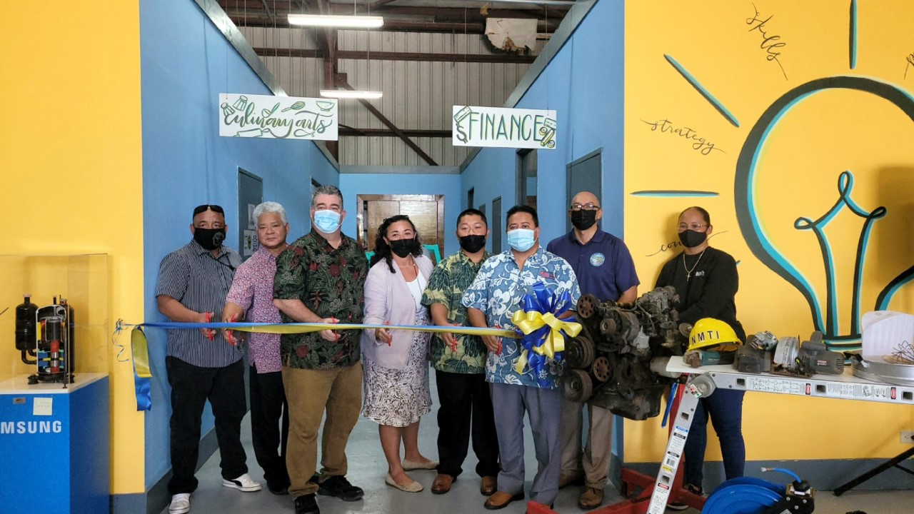 From left, NMHC CDBG-DR program manager Kimo Rosario, Lt. Gov. Arnold I. Palacios, NMTI board chair Mario Valentino, House Committee on Education Chair Leila Staffler, CNMI Youth Sen. Easton Dela Cruz, Gov. Ralph DLG Torres, NMHC corporate director Jesse Palacios, and NMTI interim CEO Jodina Attao prepare to cut a ribbon to mark the opening of the new NMTI financial aid office.